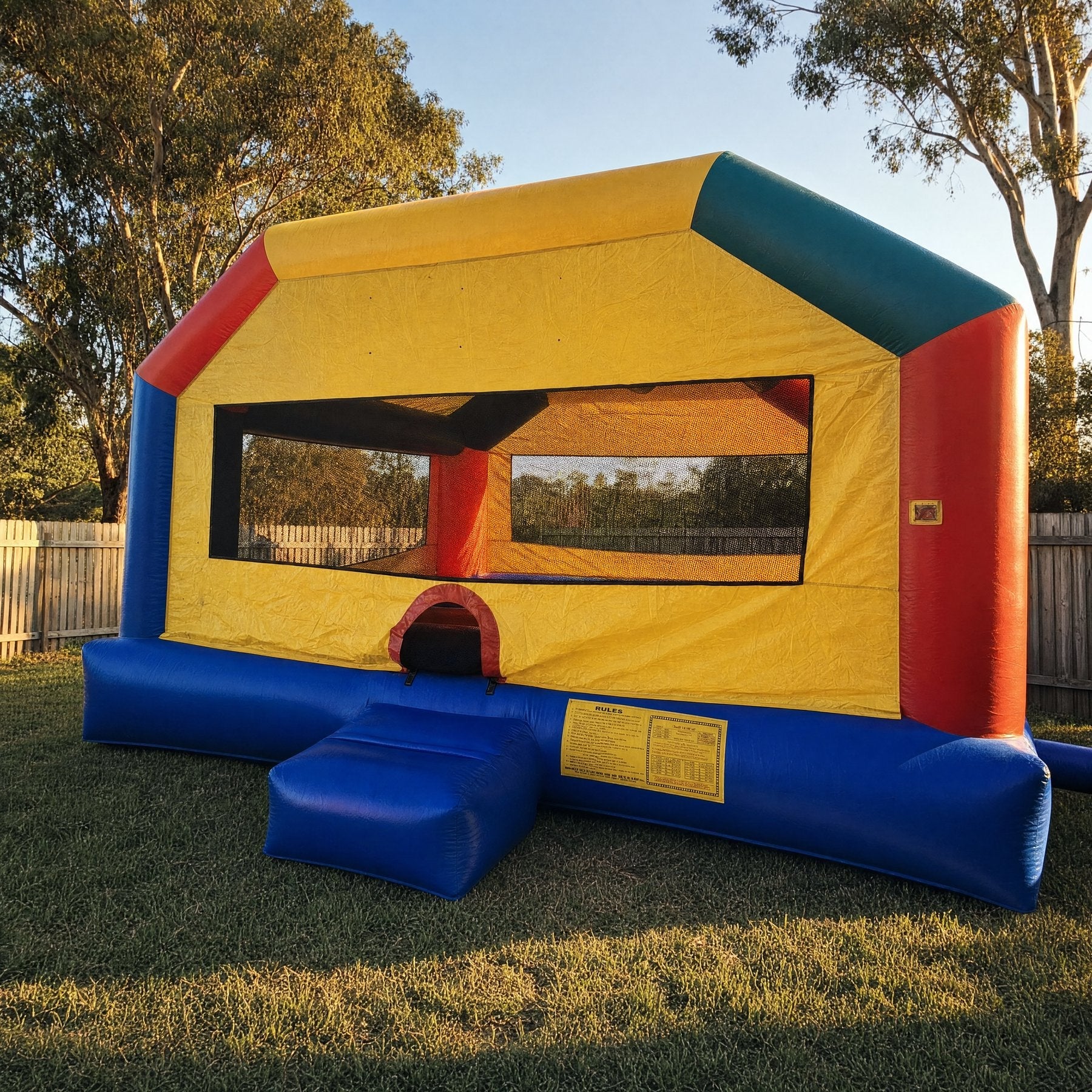 Adult Fun House jumping castle rated for grown-ups on backyard lawn, Jump About adult inflatable hire Central Coast