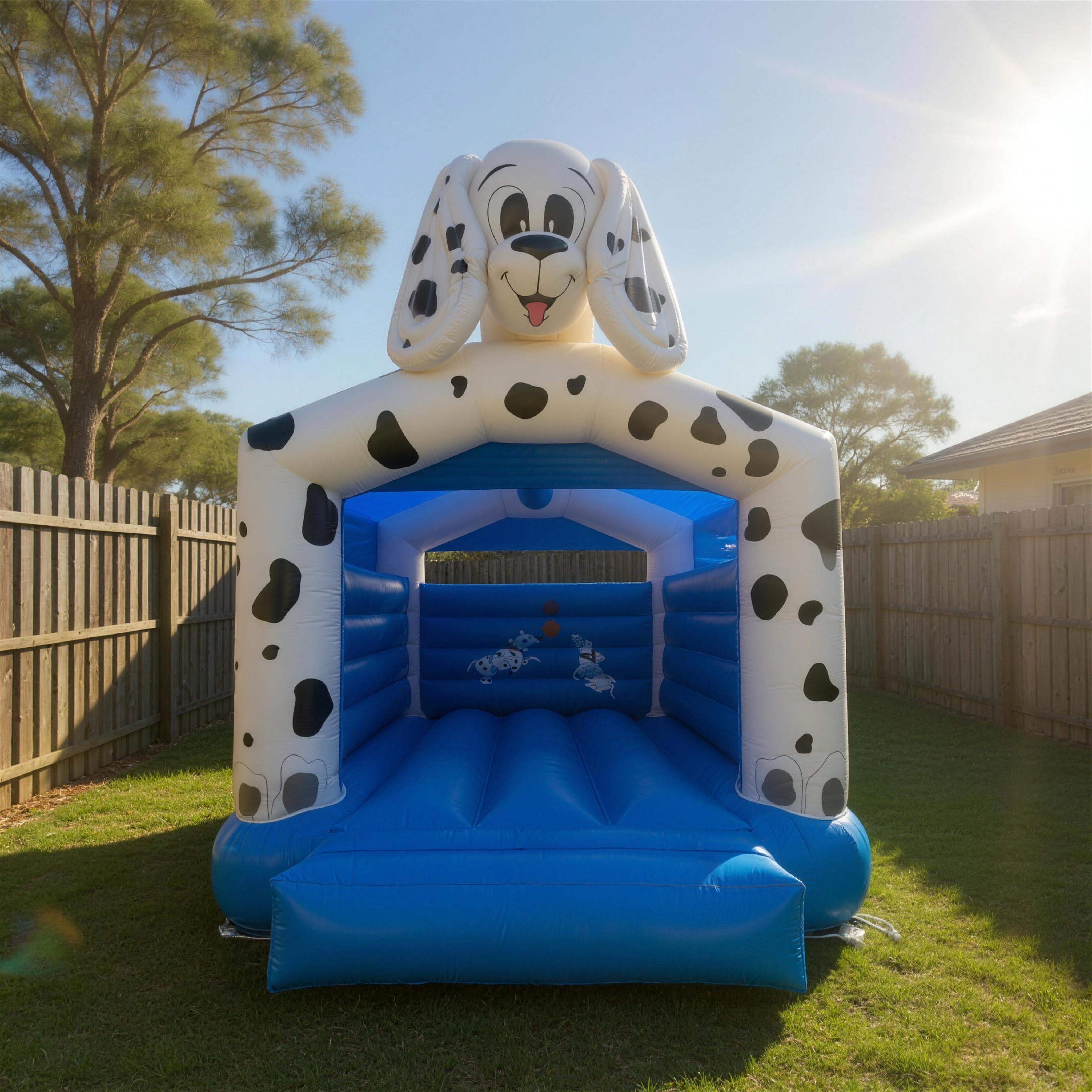 101 Dalmatians jumping castle hire set up in a Central Coast backyard, featuring Pongo, Perdita and the spotted puppies on a 3D dog-head topper.