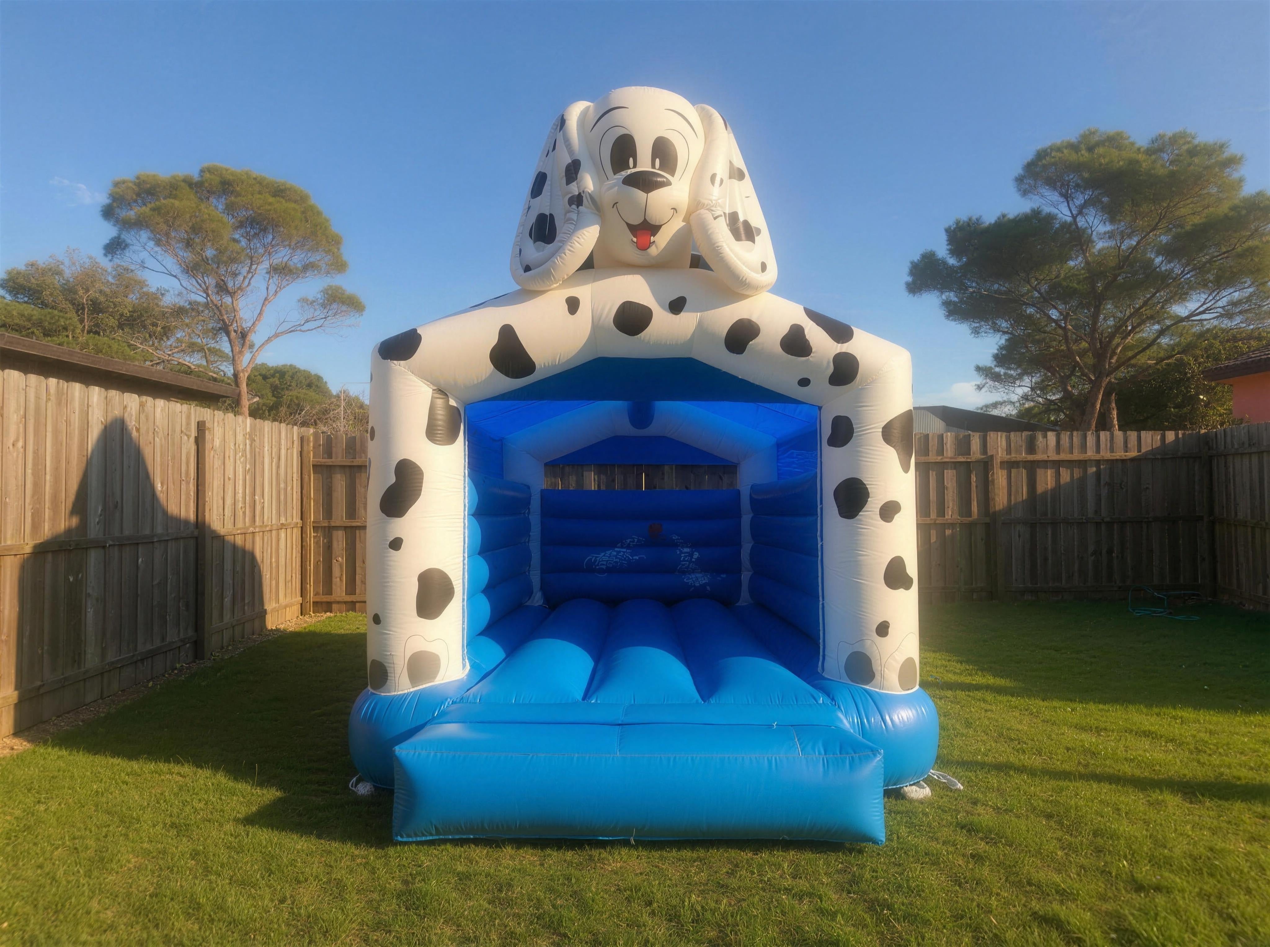 Wide shot of the 101 Dalmatians jumping castle showing scale in a real Central Coast backyard.