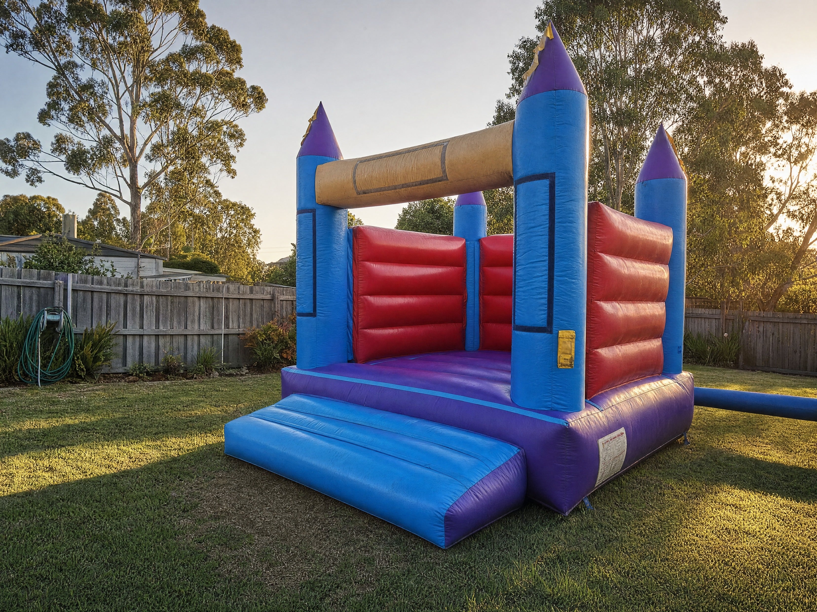 13ft Open Banner Jumping Castle Hire - wide backyard scale view