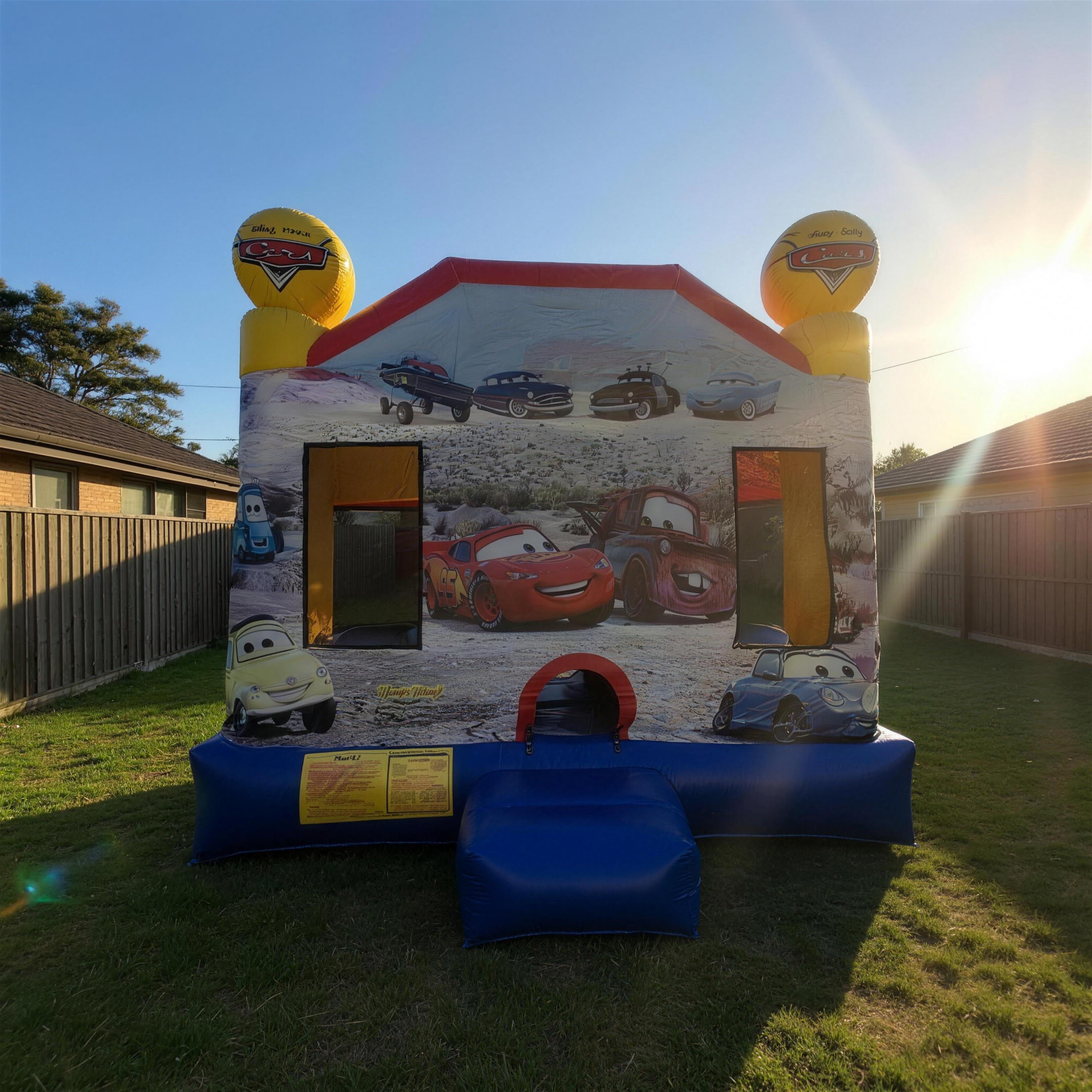 Cars C4 Combo jumping castle set up in a Central Coast backyard at golden hour