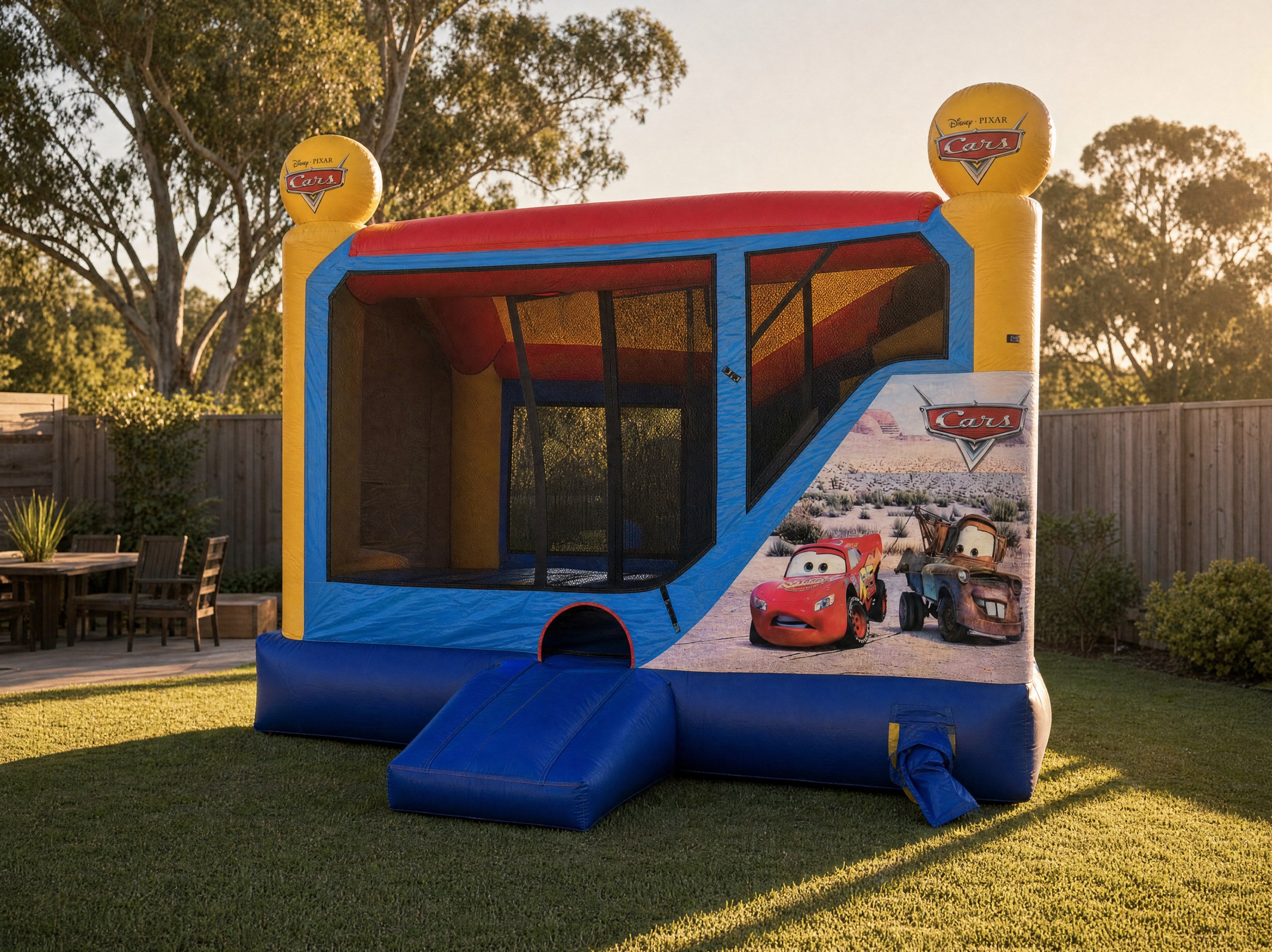 Cars C4 Combo jumping castle three-quarter view showing the entry ramp and side artwork