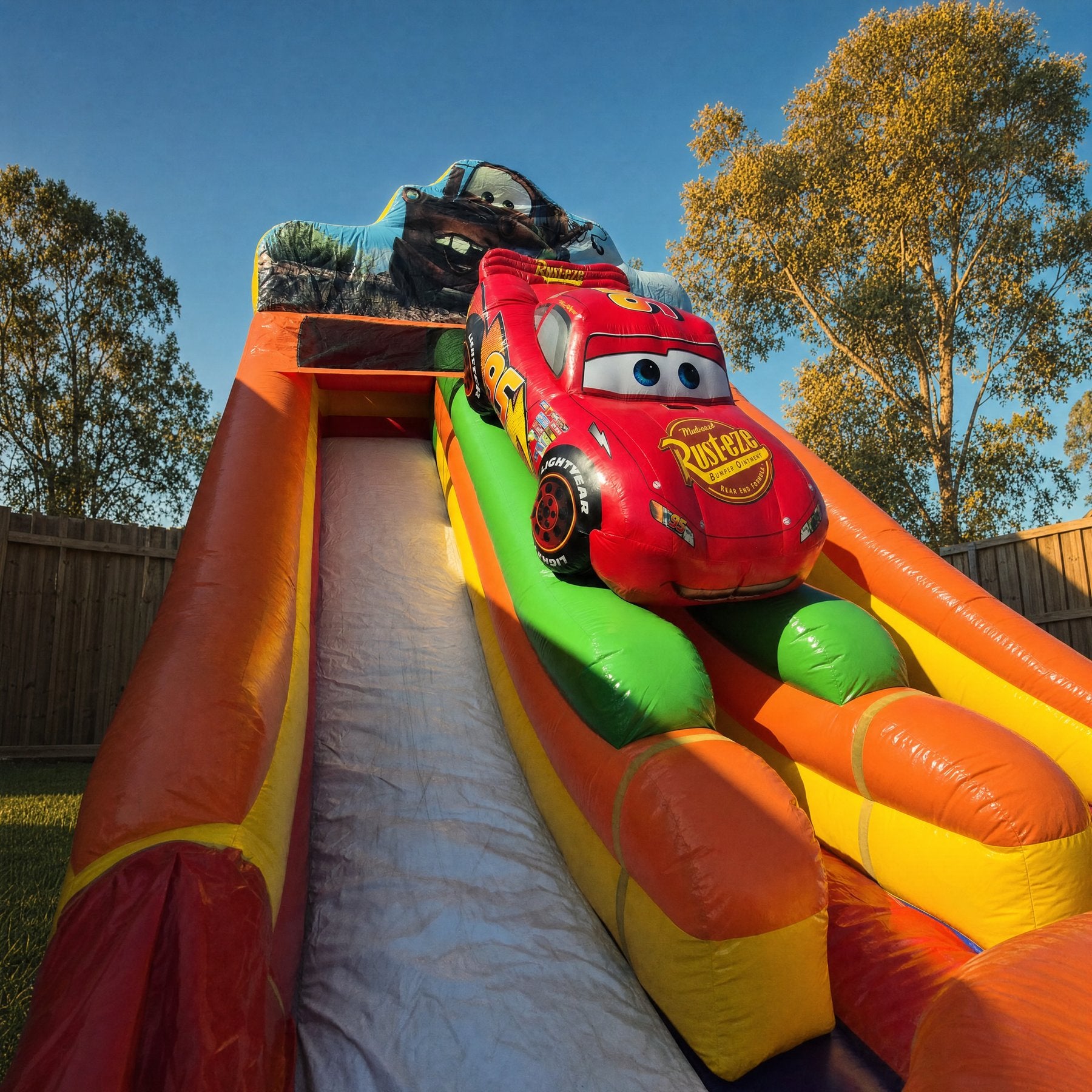 Cars Double Lane Dry Slide Hire - dramatic low view up the front at Lightning McQueen and Mater topper