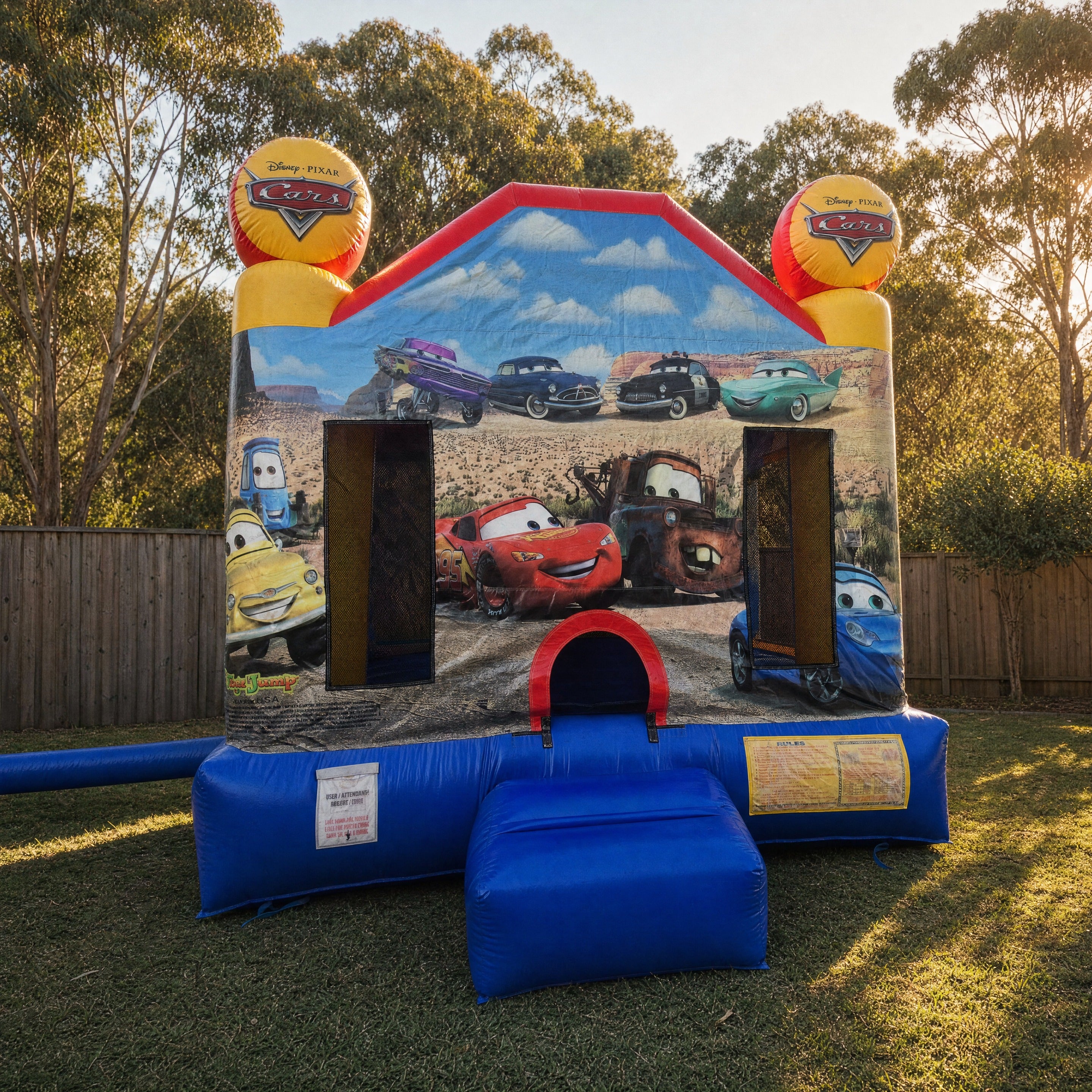 Cars Jumping Castle set up in a Central Coast backyard at golden hour