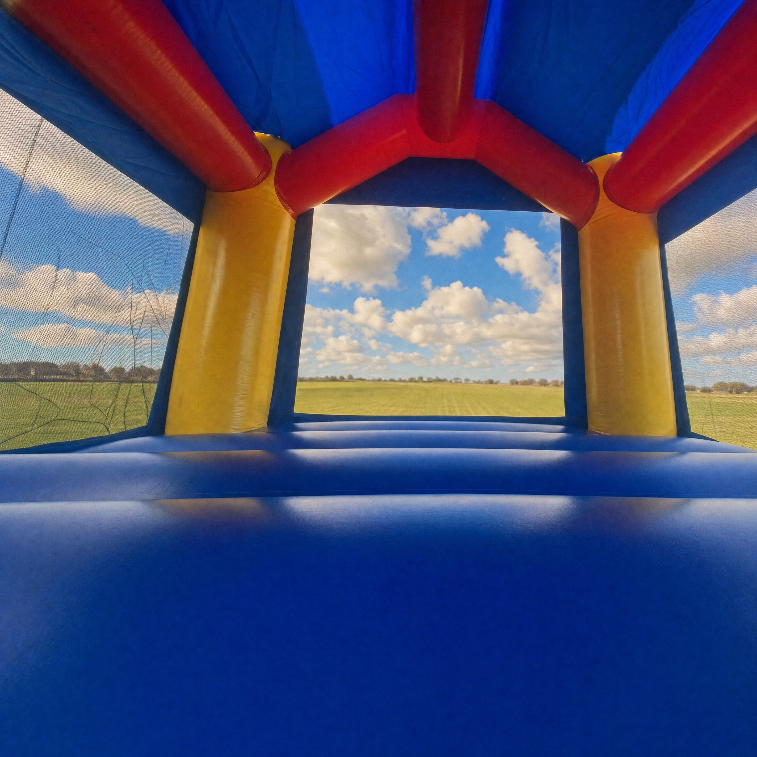 Interior view through the Cars Jumping Castle entrance looking out to the backyard