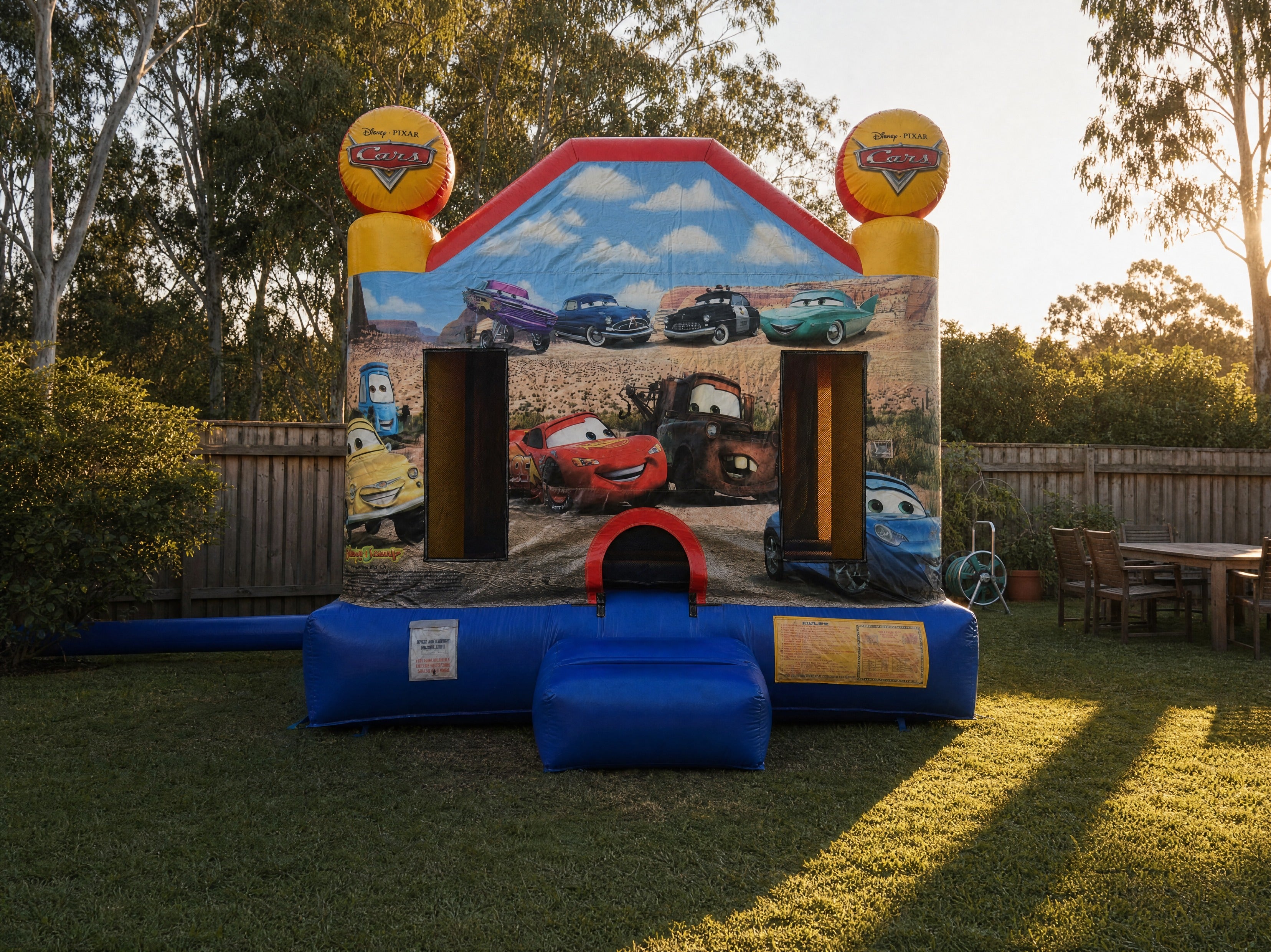 Wide view of the Cars Jumping Castle filling a Central Coast backyard