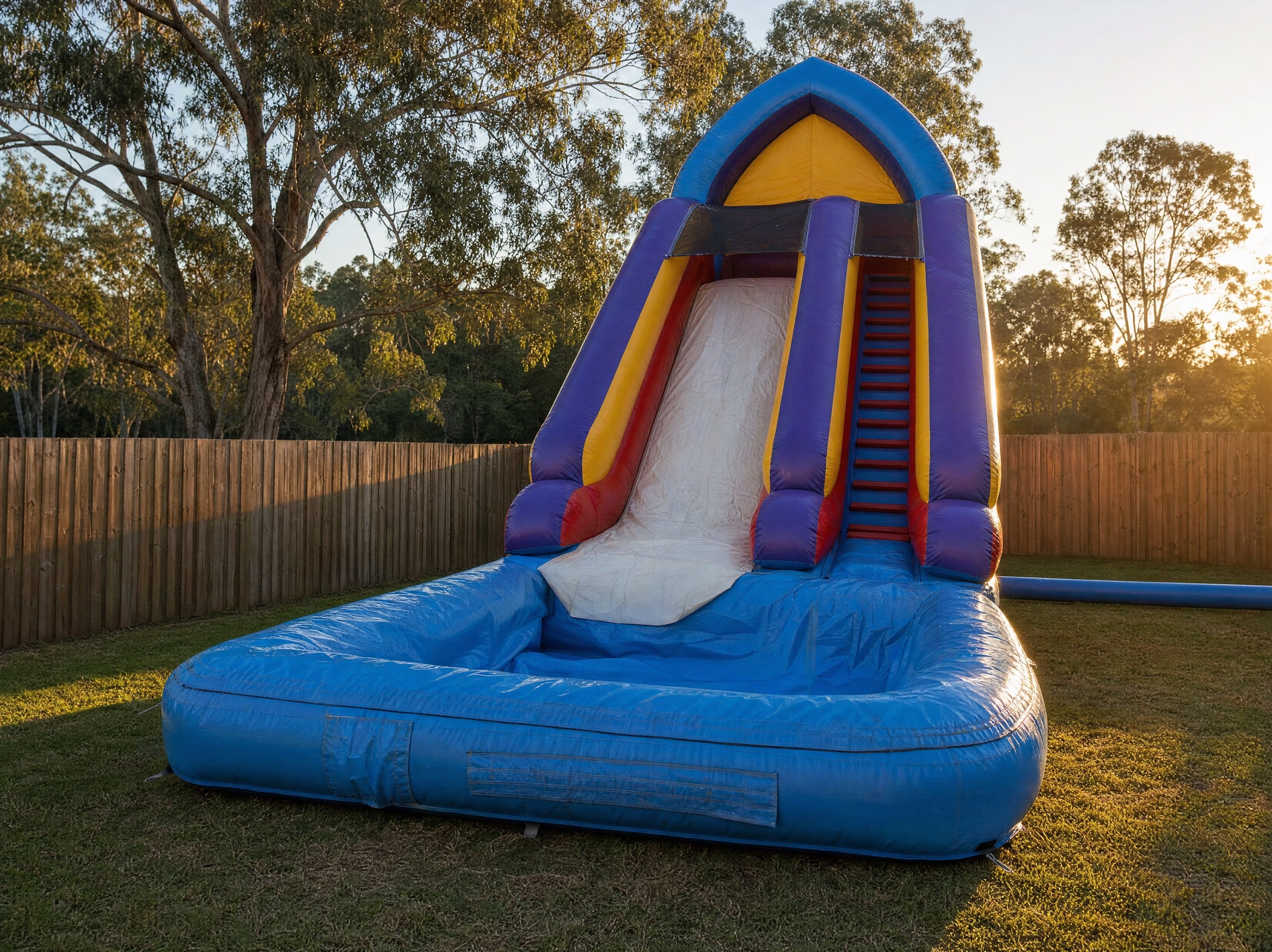 Cone Top Water Slide hire set up in a Central Coast backyard at golden hour