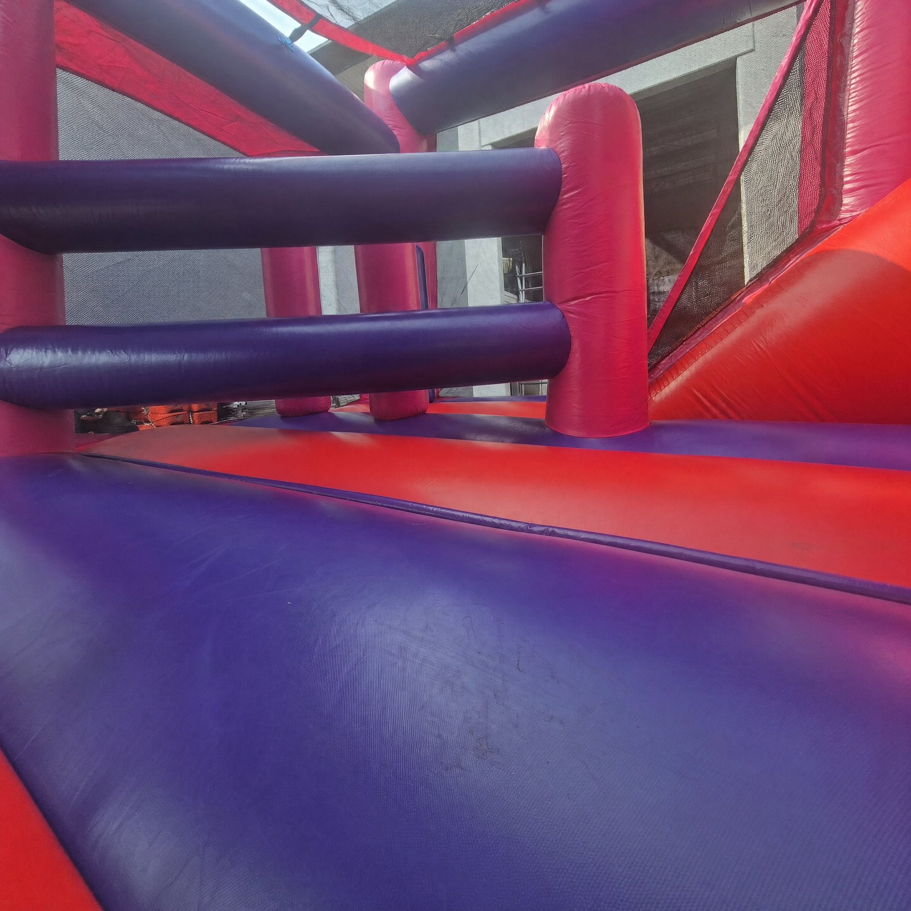 Interior of an inflatable combo castle showing padded climbing pillars