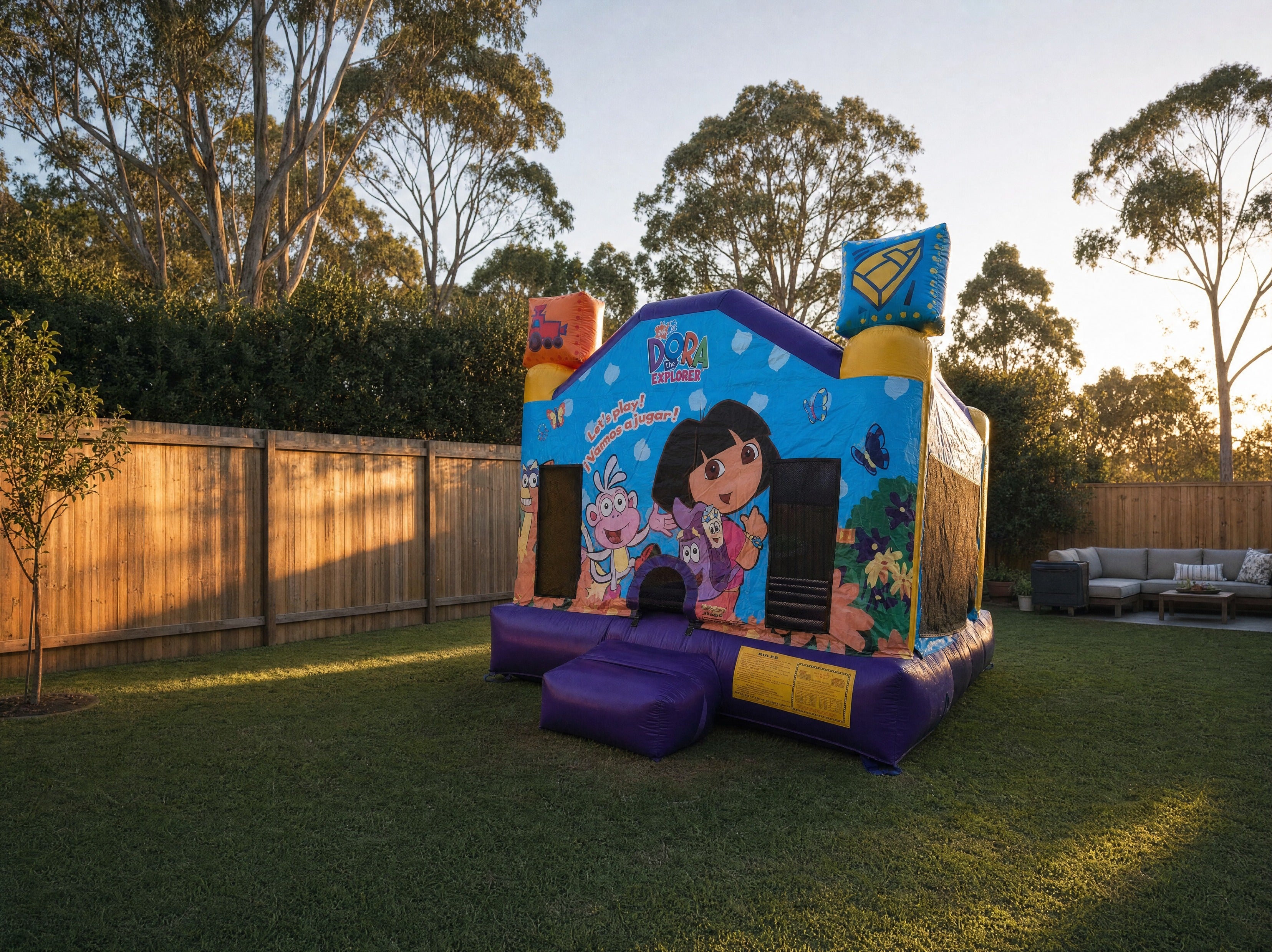 Dora Jumping Castle wide backyard scale context shot