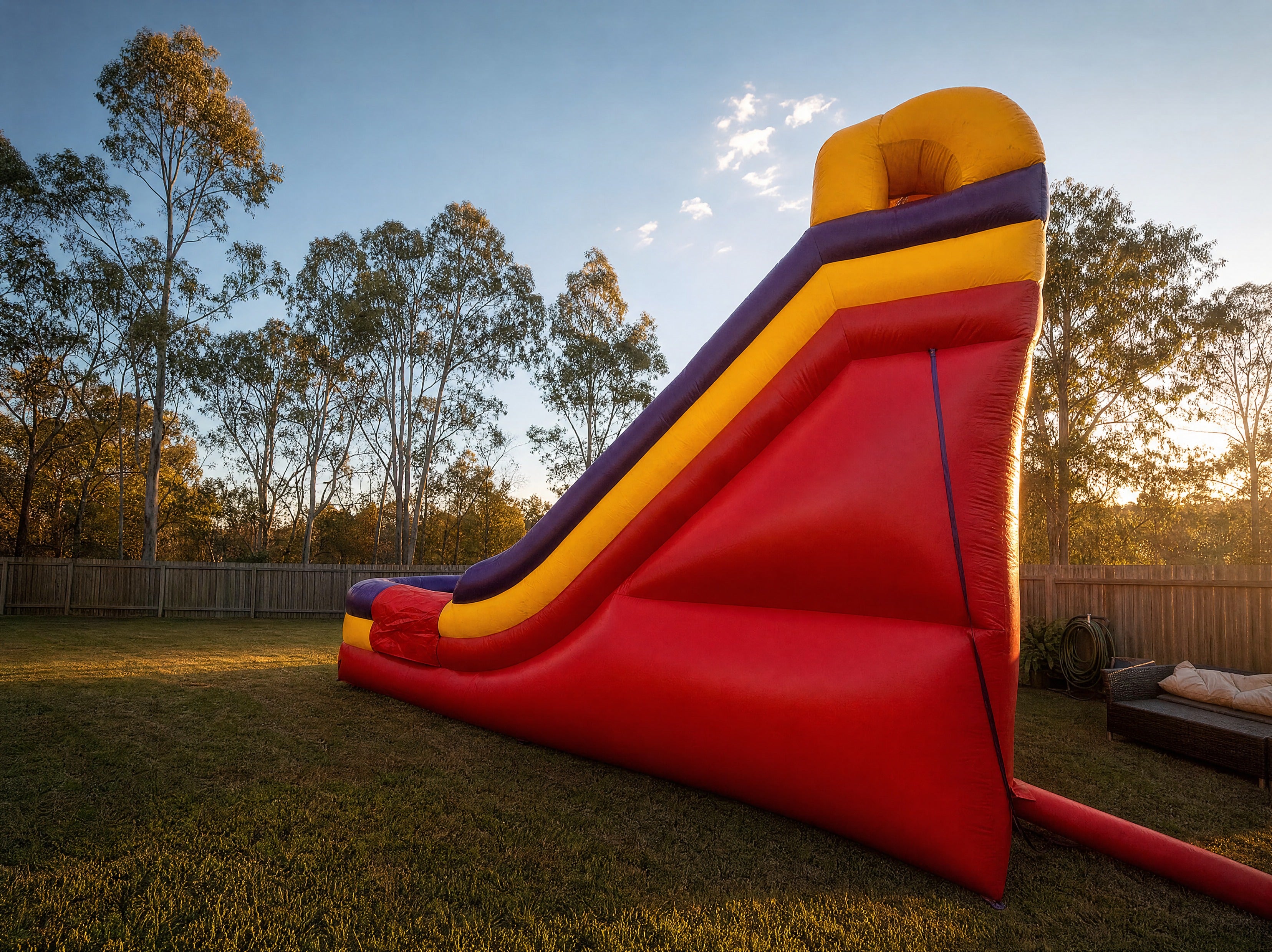 Double lane dry slide hire, pulled-back backyard scale view