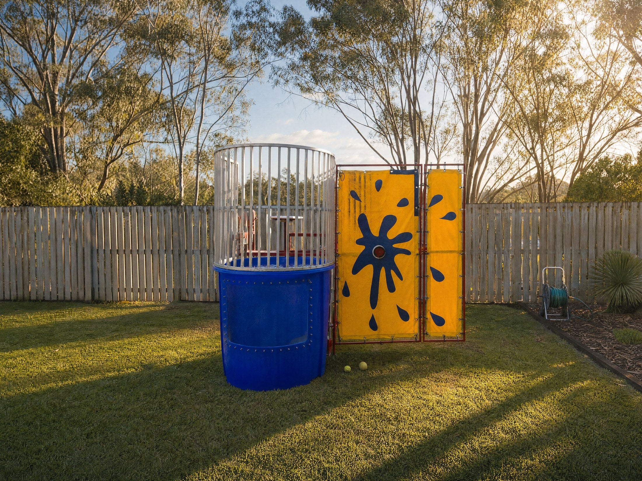 Wide scale view of the Dunk Tank hire in a real Central Coast backyard, Jump About