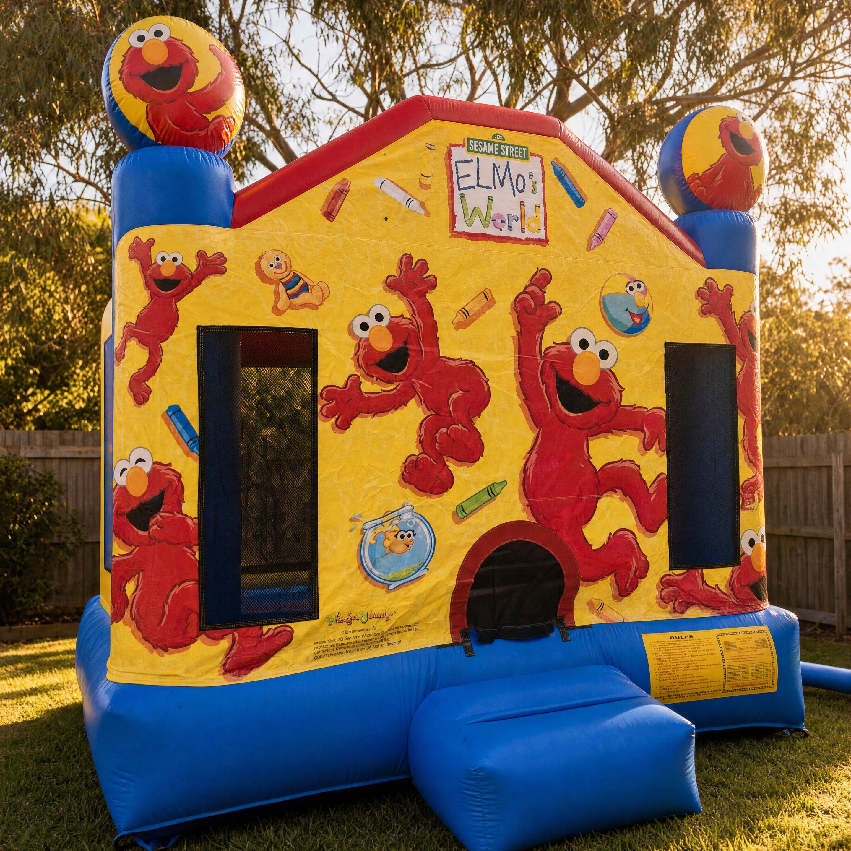 Elmo's World Jumping Castle set up in a Central Coast backyard, front three-quarter view