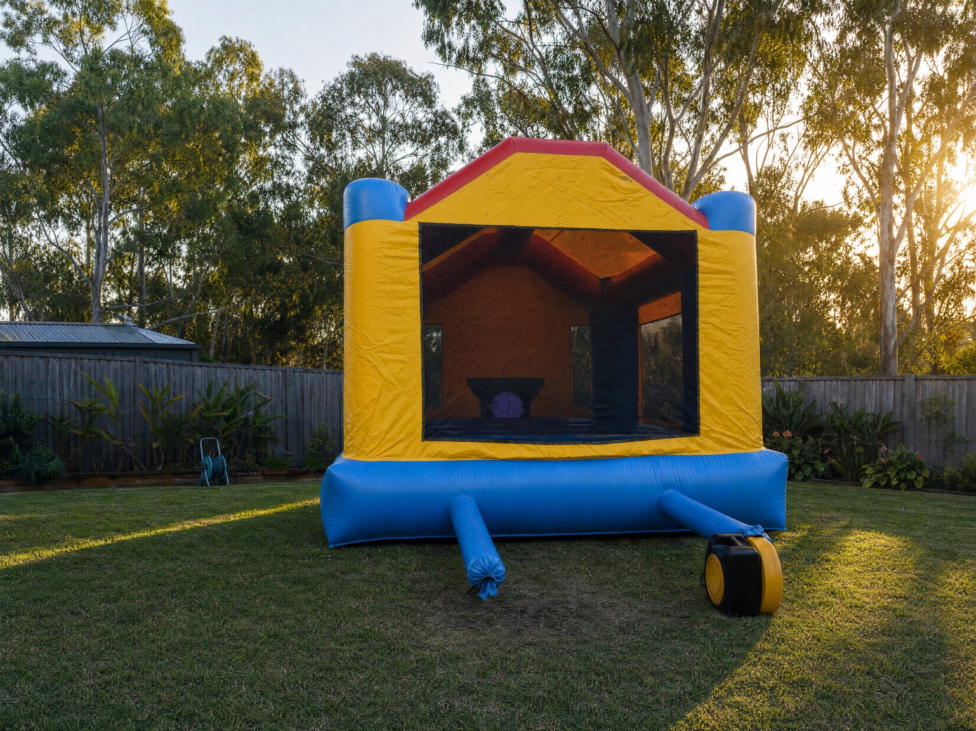 Elmo's World Jumping Castle rear elevation in a backyard setting