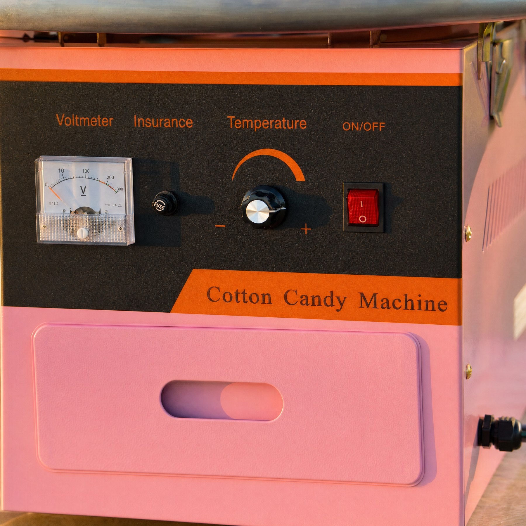 Close-up of a fairy floss machine control panel showing the voltmeter, temperature dial, and on/off switch