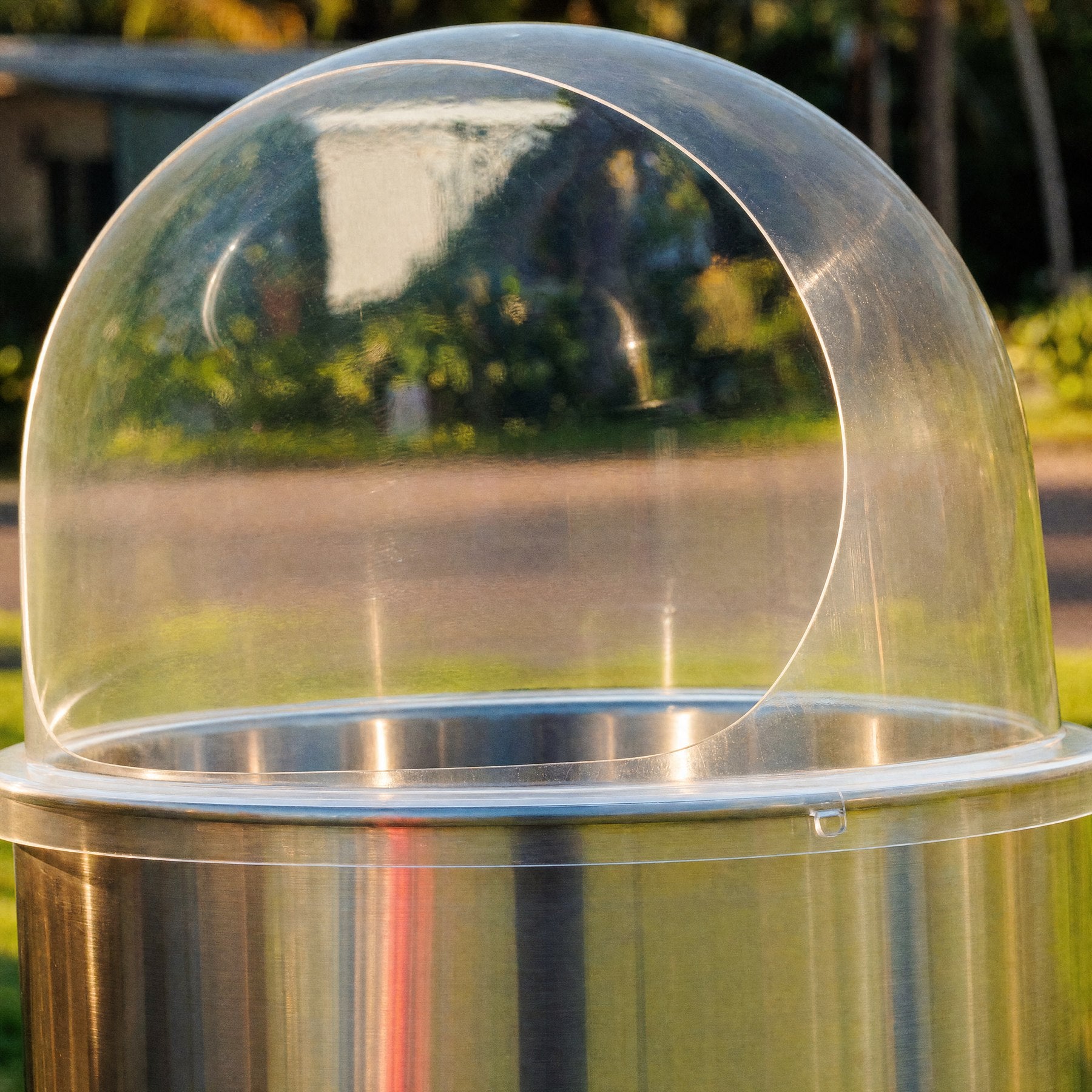 Close-up of the clear dome and stainless bowl on a commercial fairy floss machine
