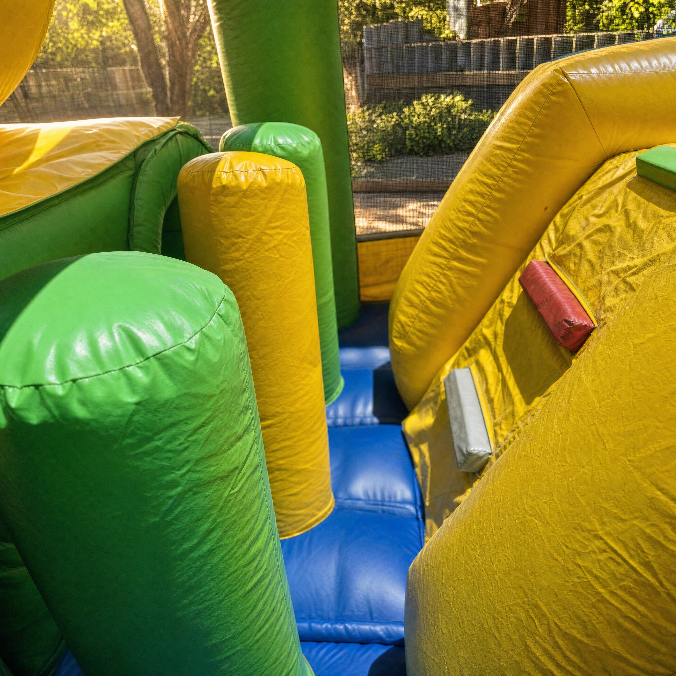 Interior obstacle posts inside the Footy Obstacle Challenge on the blue landing surface