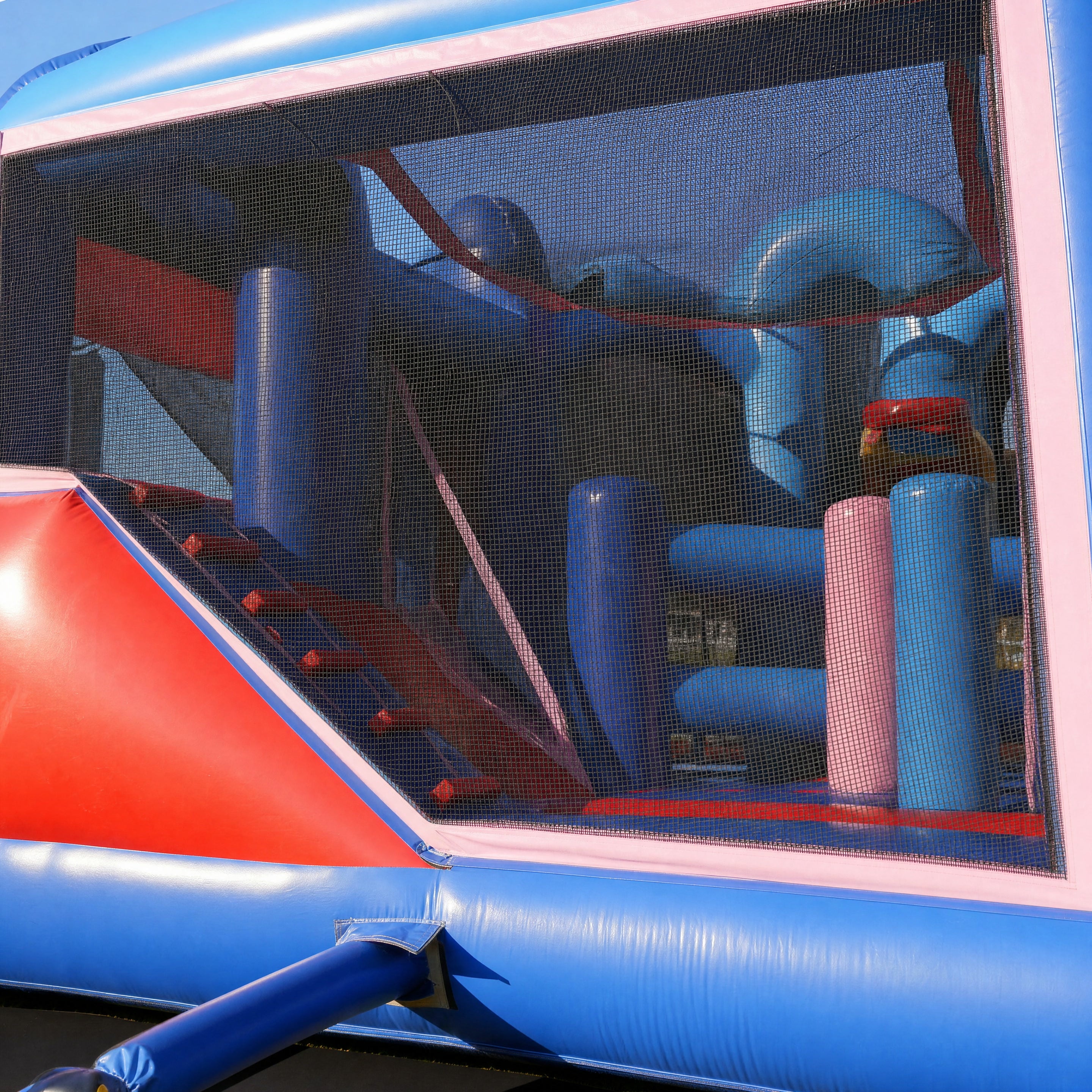 Interior obstacle and climbing structure inside the Frozen 5in1 Combo through the mesh window