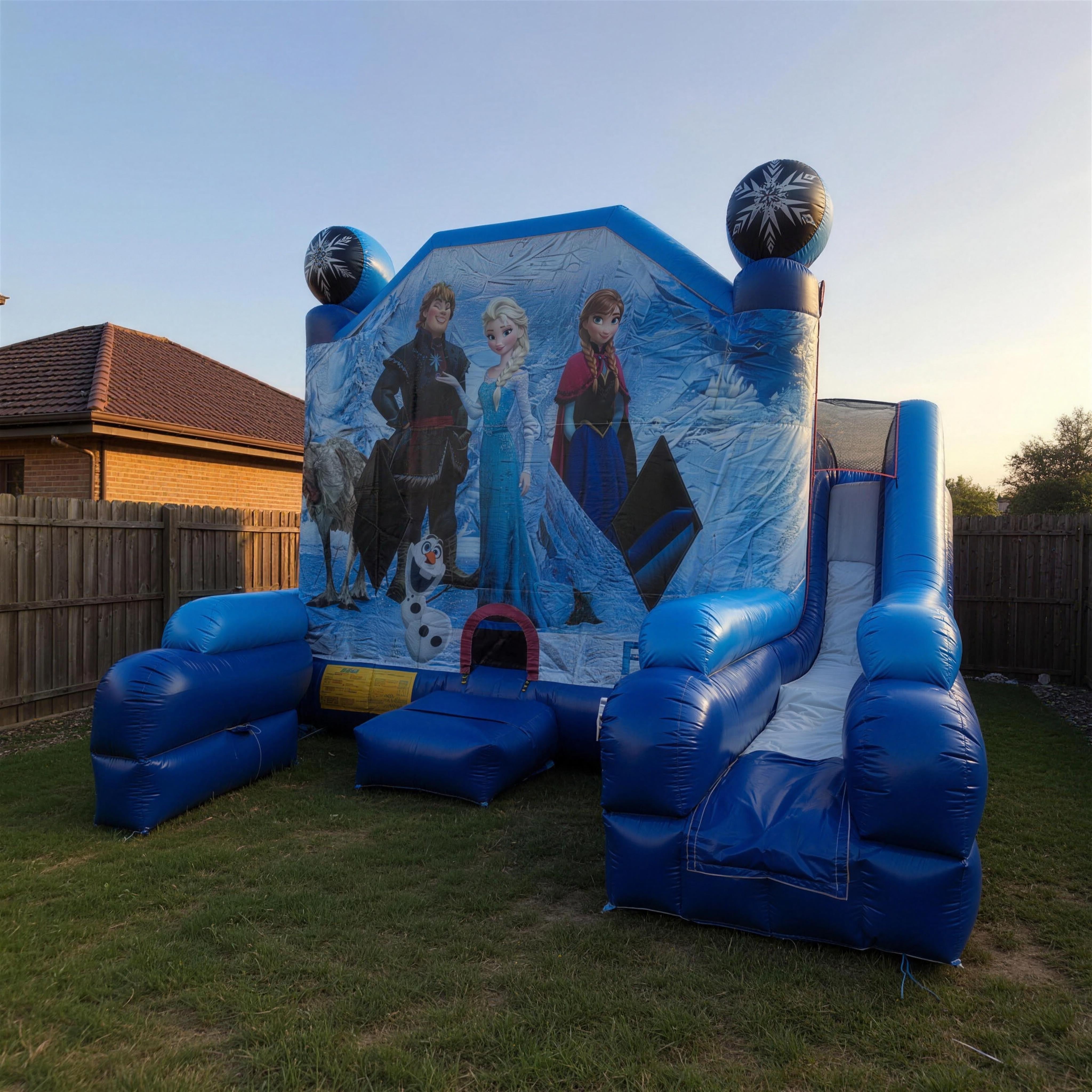 Frozen C7 Combo Castle set up in a Central Coast backyard with Elsa, Anna, Kristoff and Olaf