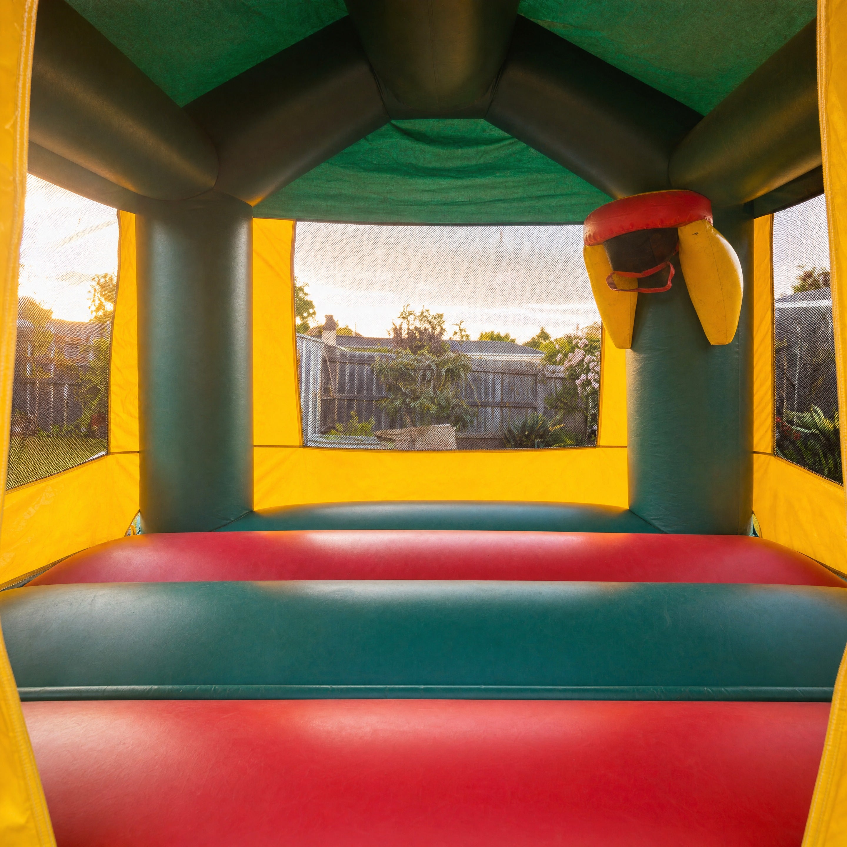 Green Dinosaur Jumping Castle hire, interior view through the entrance doorway