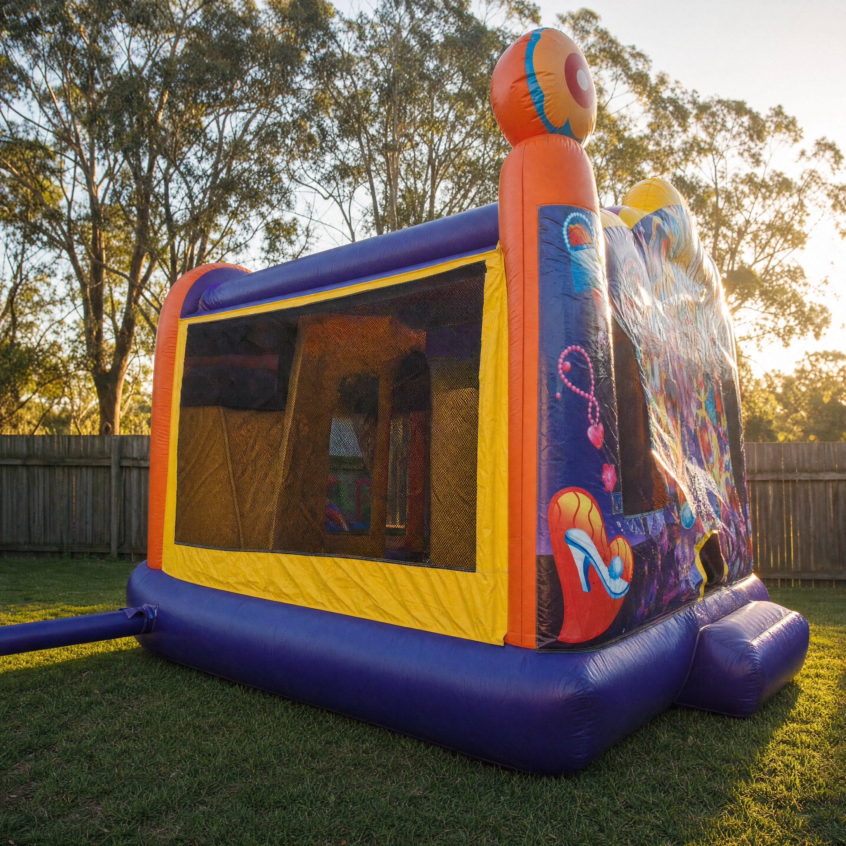 Side profile of a purple jumping castle showing a heart and shoe motif panel