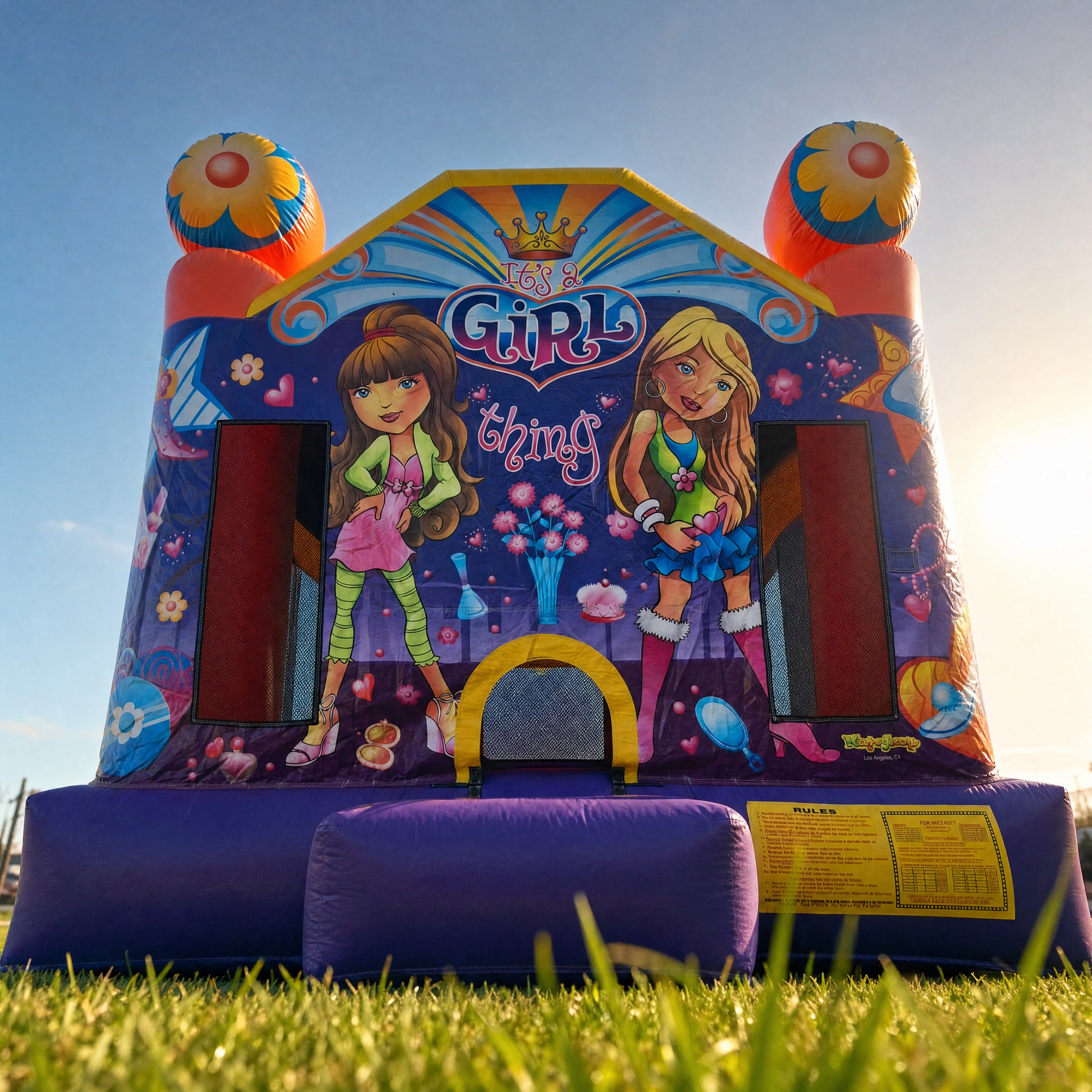 Low angle view of the It's a Girl Thing Jumping Castle towers and flower toppers