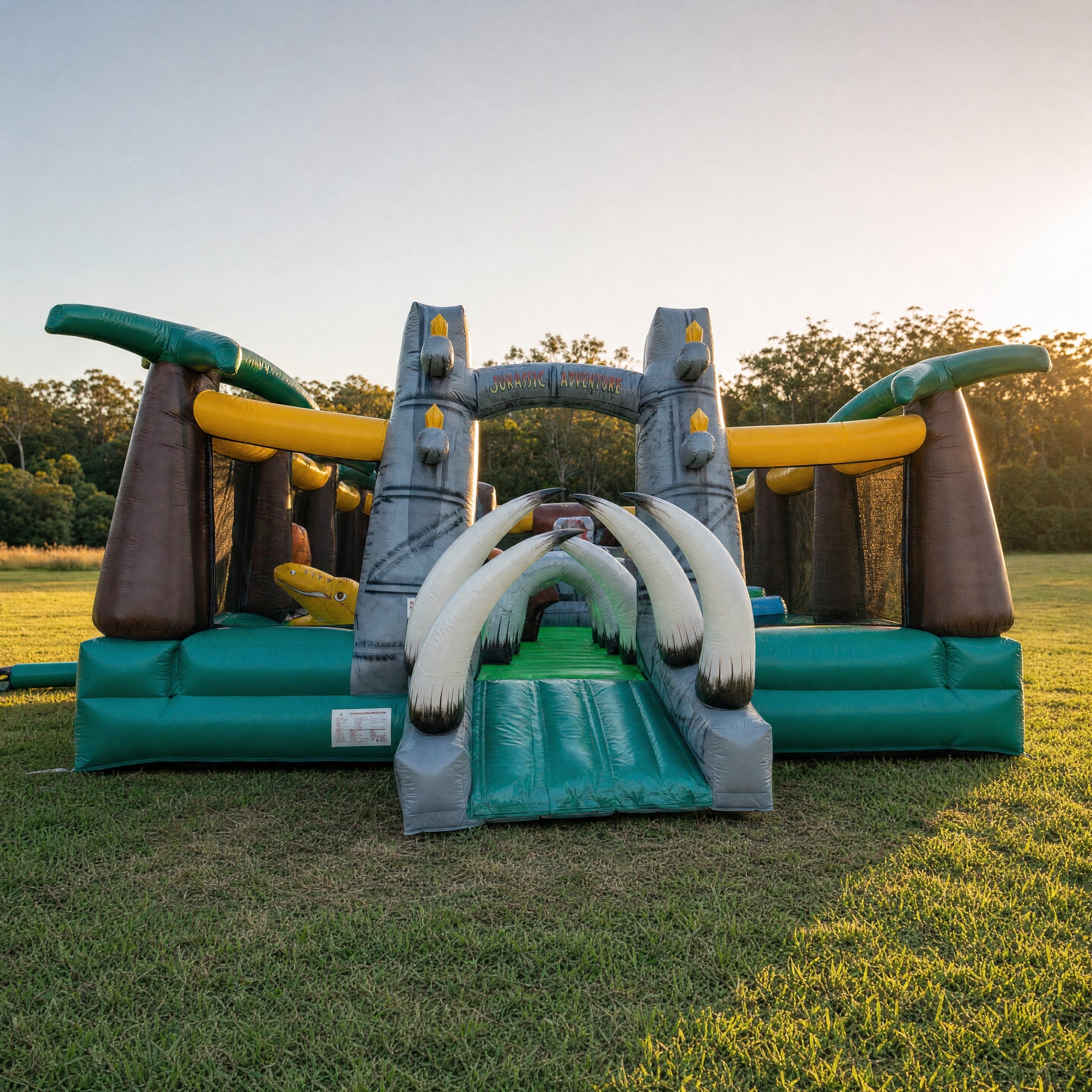 Jurassic Adventure Obstacle inflatable course with tusk archway on a Central Coast field