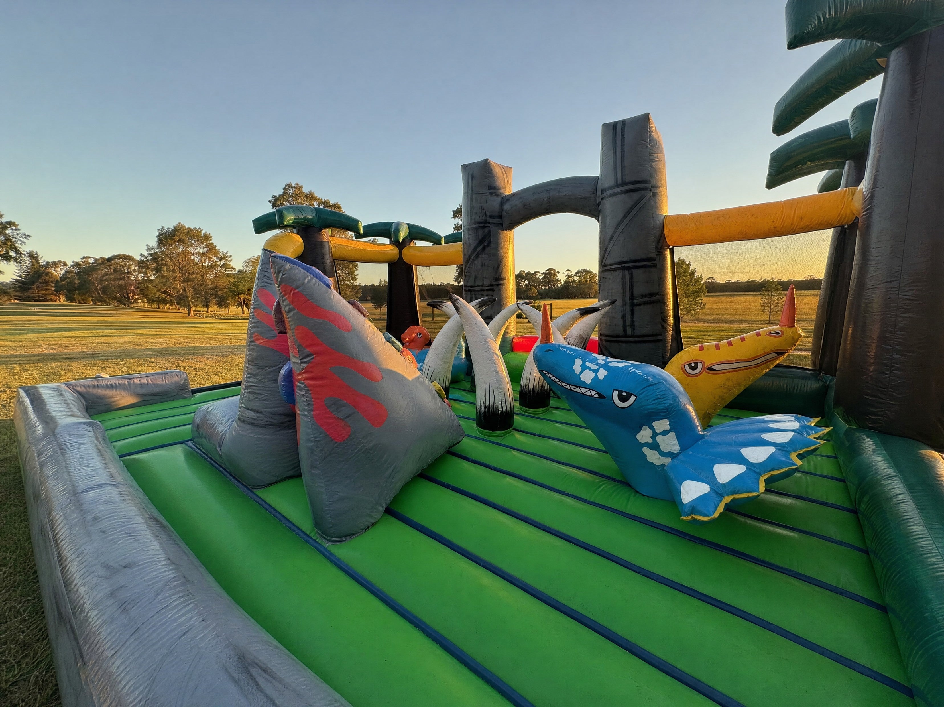 Wide interior view of the Jurassic Adventure Obstacle climbing wall and dinosaur figures