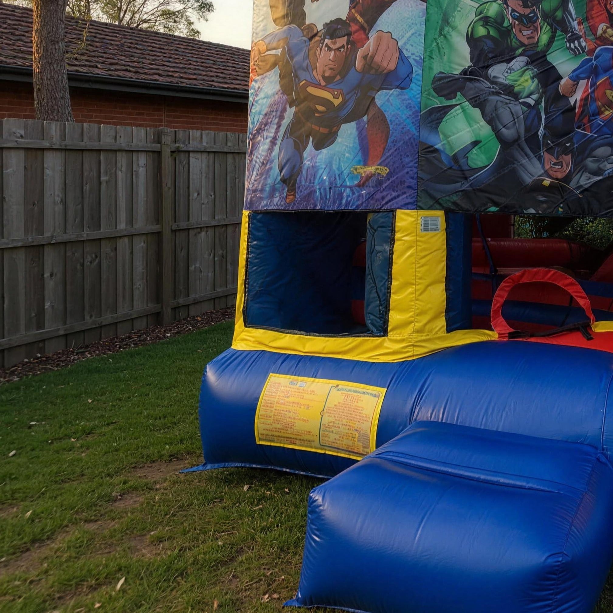 Justice League 5in1 Combo jumping castle side character panel in a Central Coast yard