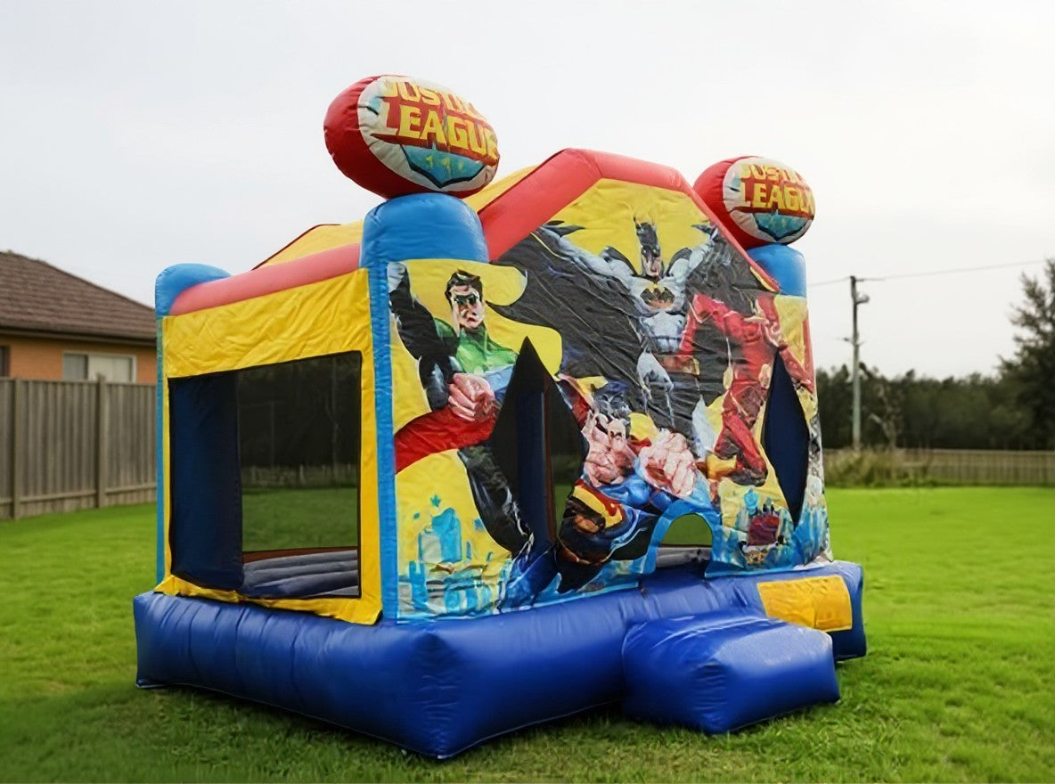 Wide pulled back view of the Justice League jumping castle showing yard scale