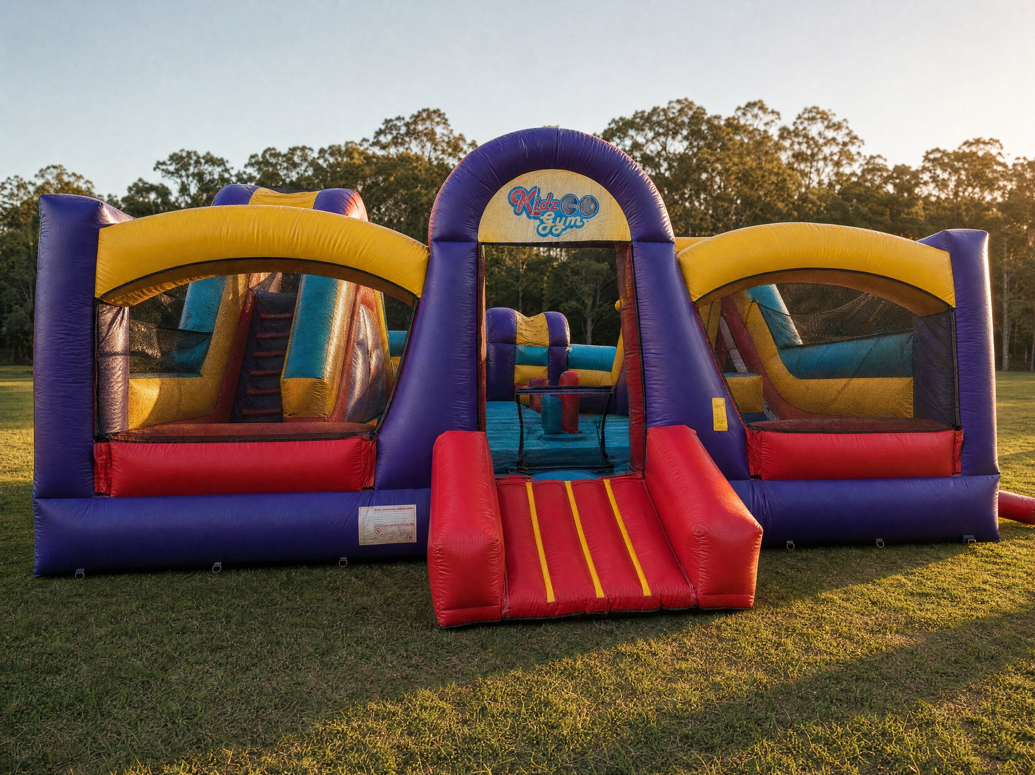 Front view of the Kids Gym Obstacle with the Kidz Gym archway and red entrance ramp