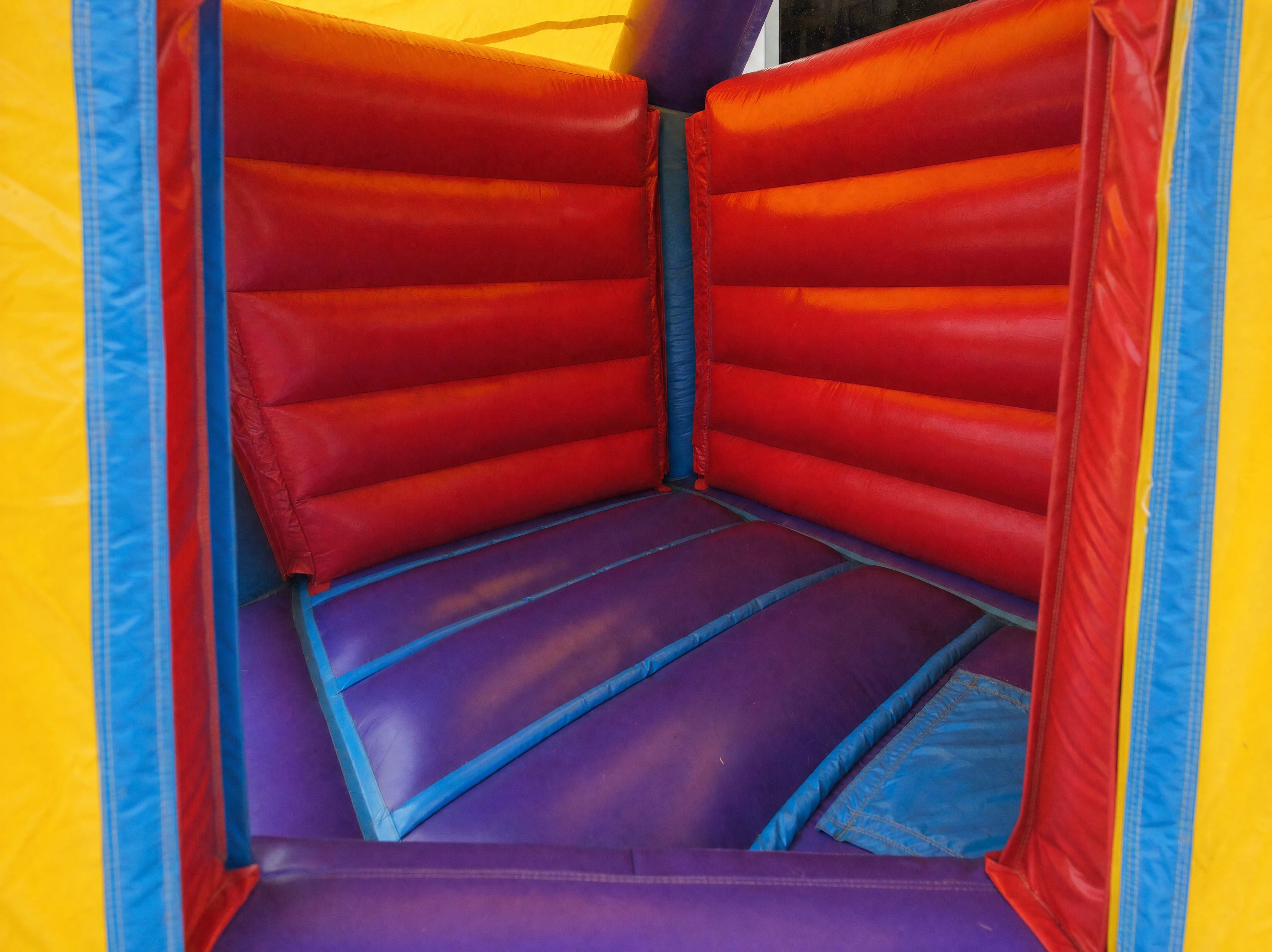 Interior view through the entrance of the module side slide banner castle combo bounce area