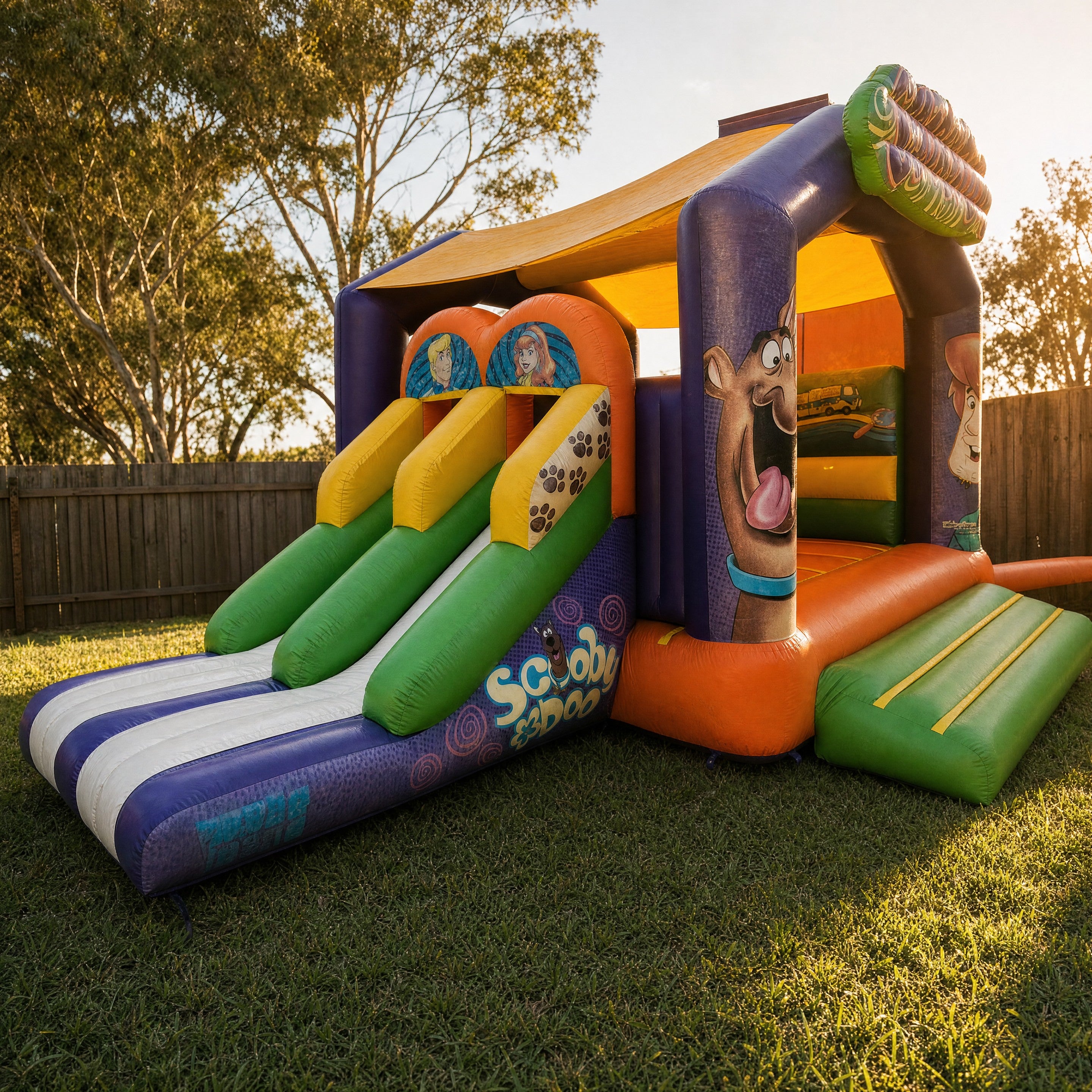Close-up of the paw print slide lanes and Scooby Doo wordmark on the jumping castle slide