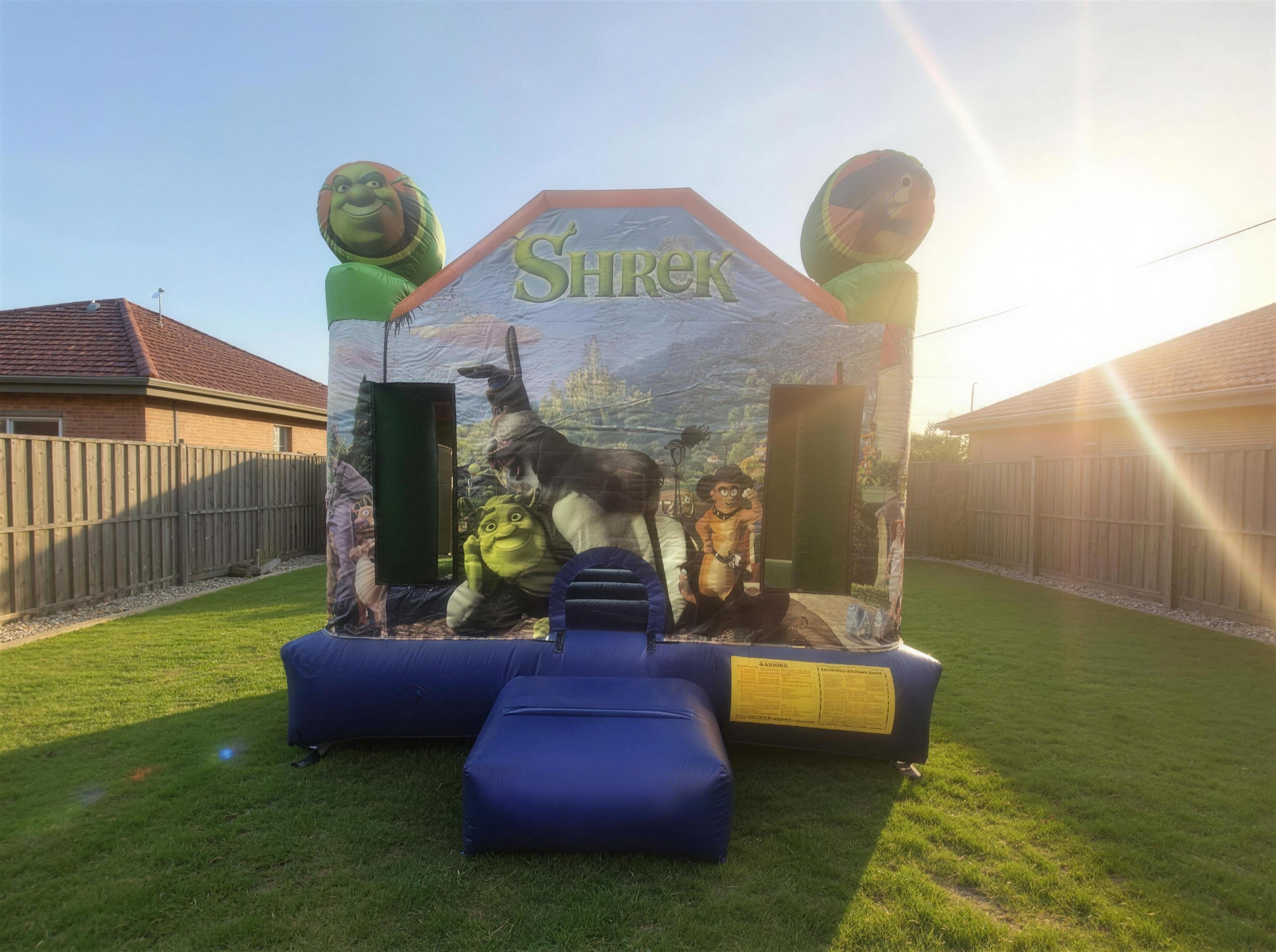 Shrek Jumping Castle wide front view with Central Coast backyard context
