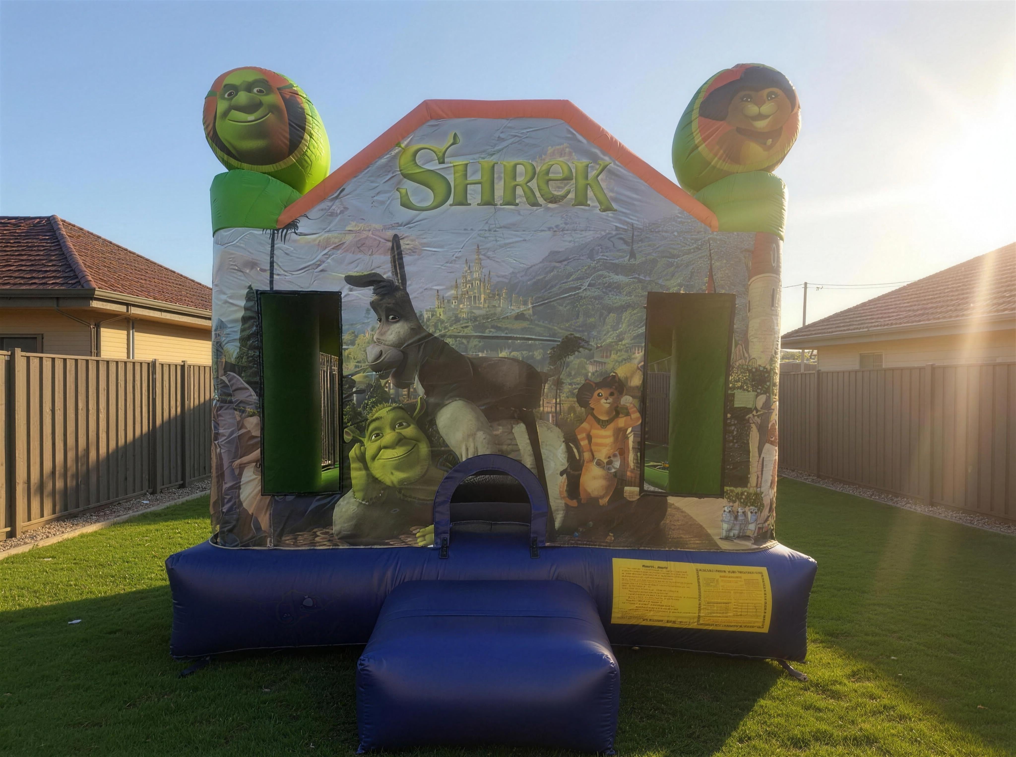 Shrek Jumping Castle Hire golden hour backyard wide view