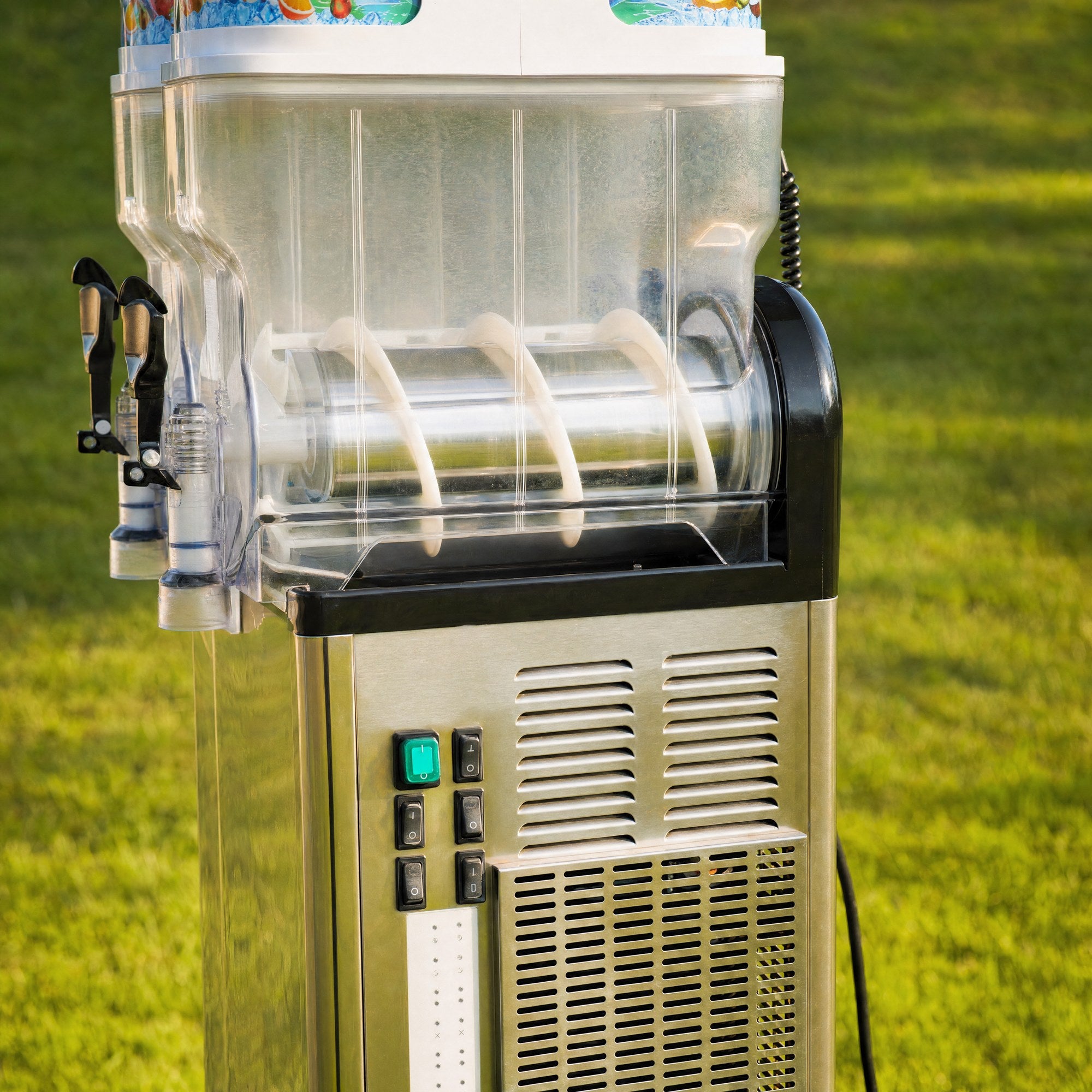 Close-up of a slushie machine control panel showing switches and vented stainless base