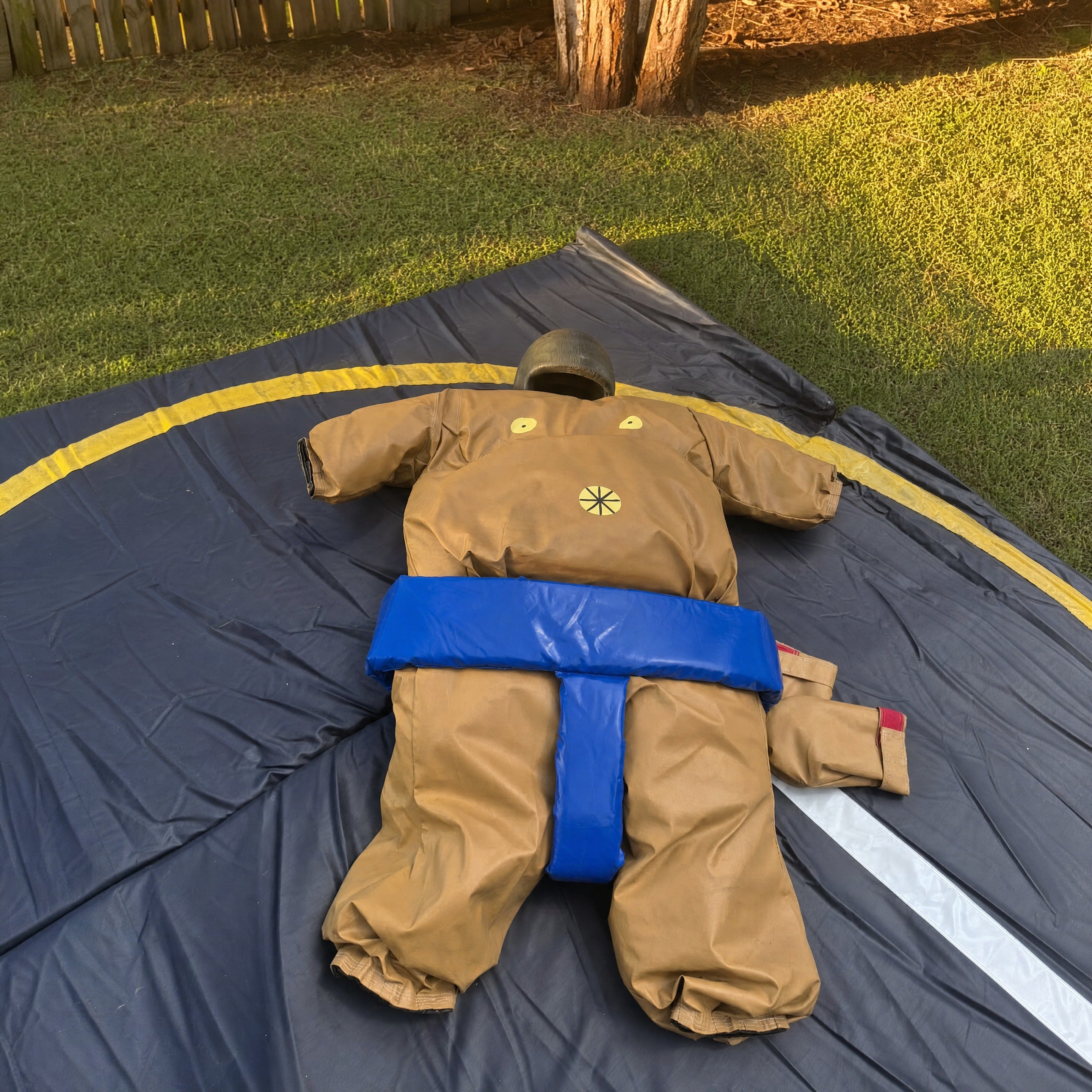 Close view of the blue-belt padded sumo suit laid flat on the mat