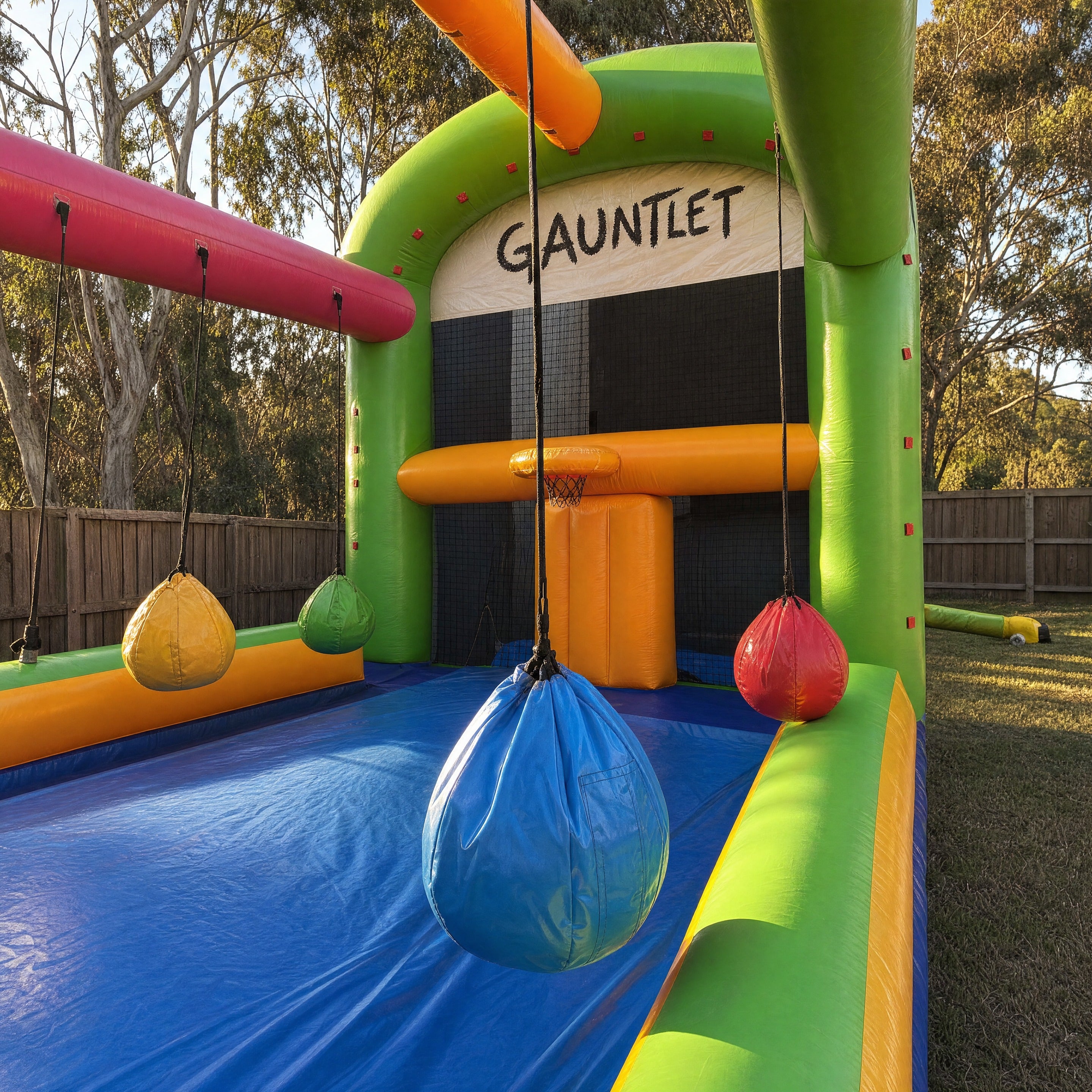 Close detail of hanging punch bag obstacles and basketball hoop on The Gauntlet inflatable