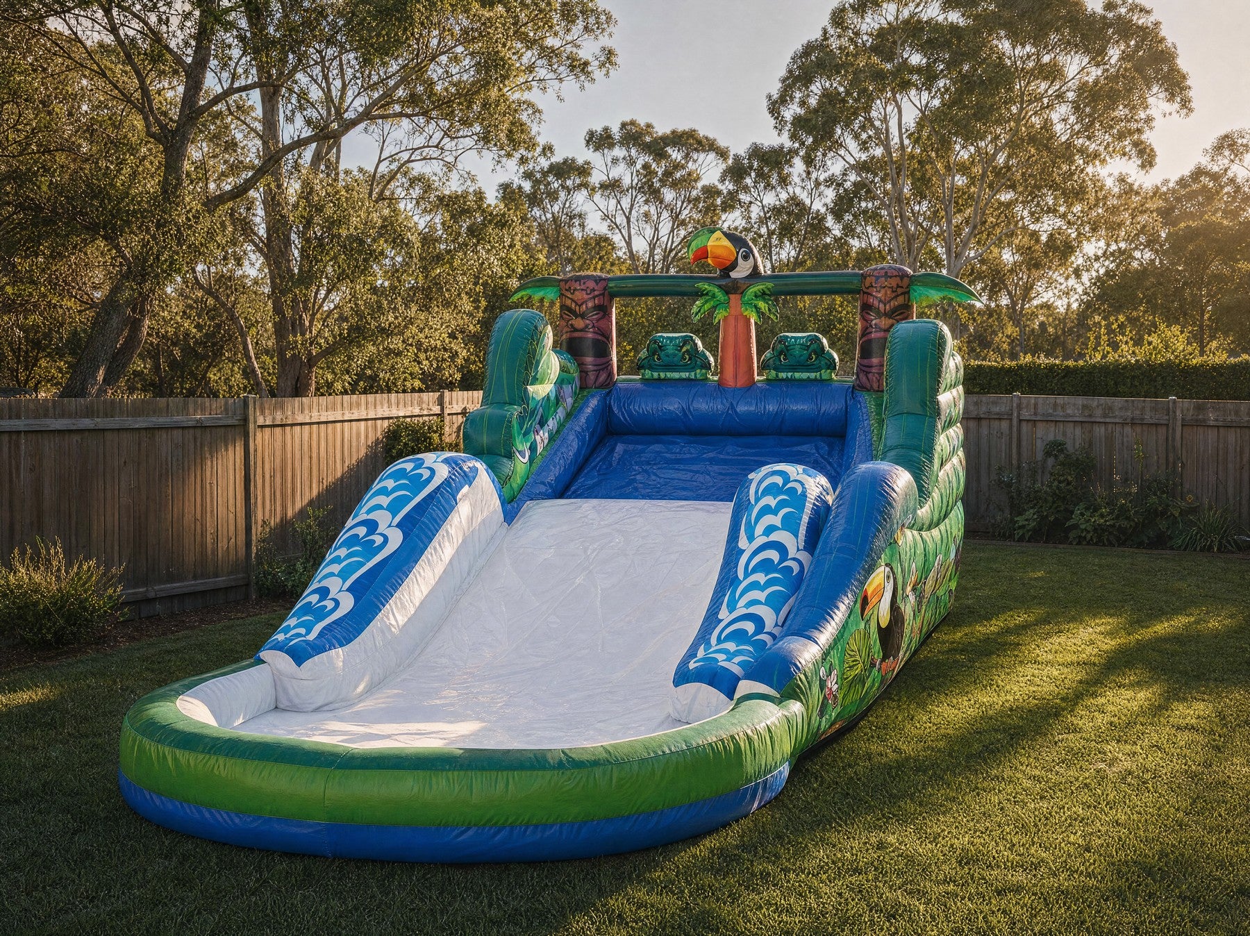 Tiki Falls Water Slide with Pool full setup showing true size in a backyard with fence and trees