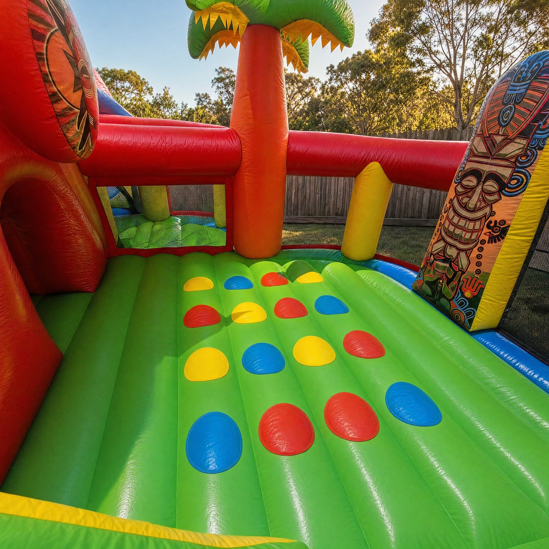 Colour-dot climbing wall detail inside the Tiki Island inflatable obstacle course