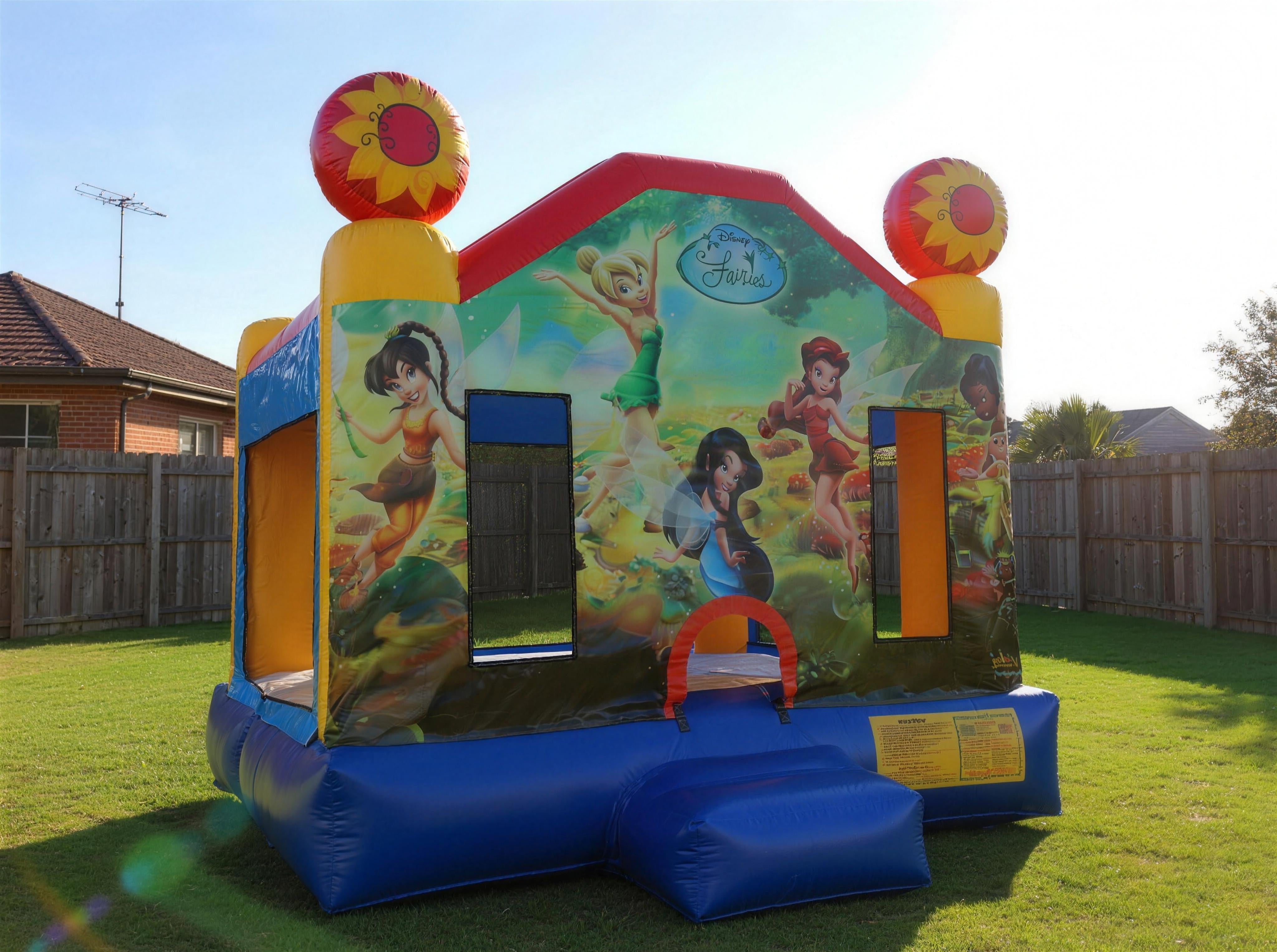 Tinkerbell Jumping Castle Hire golden hour backyard wide view with Disney Fairies artwork