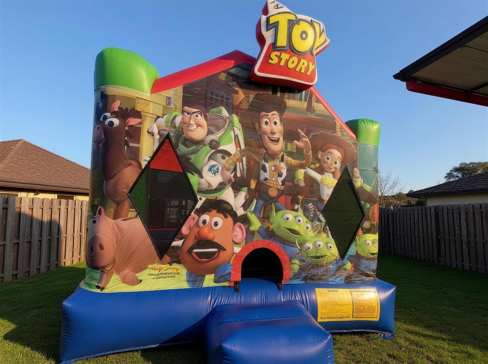 Toy Story Jumping Castle Hire, front three-quarter view, Central Coast backyard, Jump About party hire