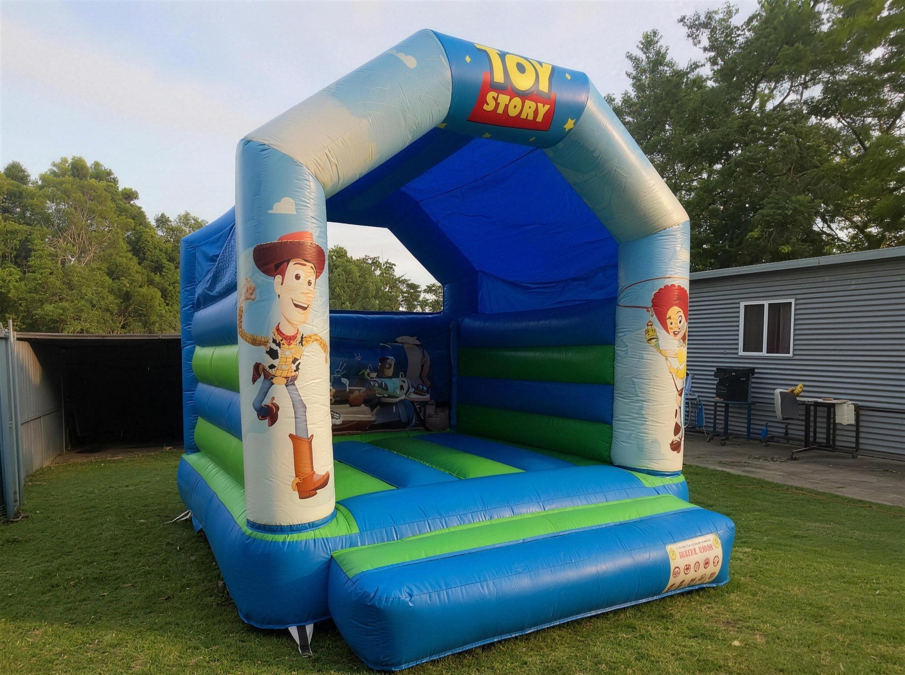 Front view of Toy Story jumping castle showing printed Woody and Jessie character panels