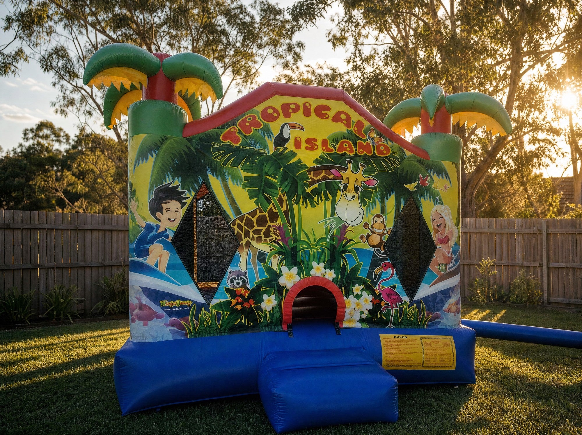 Tropical Island Jumping Castle golden hour front three-quarter view, Central Coast backyard