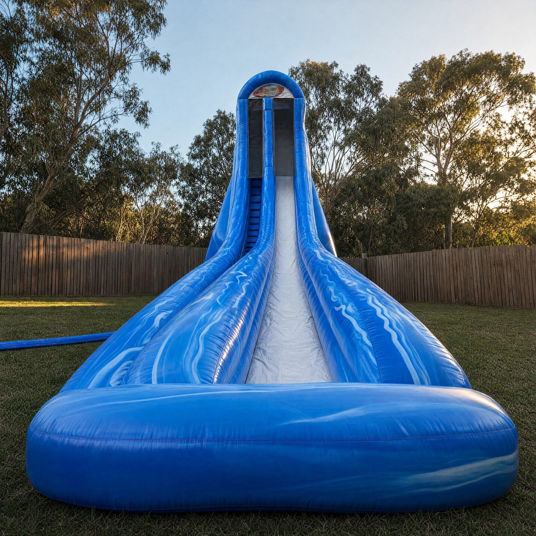 Vertical Screamer Water Slide Hire set up in a Central Coast backyard, front view