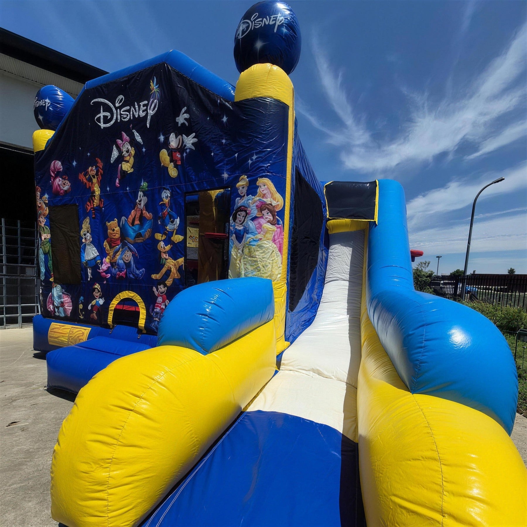 World of Disney C7 Combo jumping castle front three quarter view with attached slide